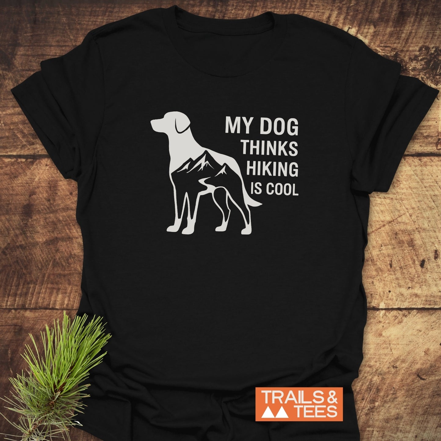 Dog Thinks... T-Shirt with a dog silhouette featuring a mountain-and-trail graphic, slogan: MY DOG THINKS HIKING IS COOL. Durable, soft ring-spun cotton, by TRAILS & TEES.