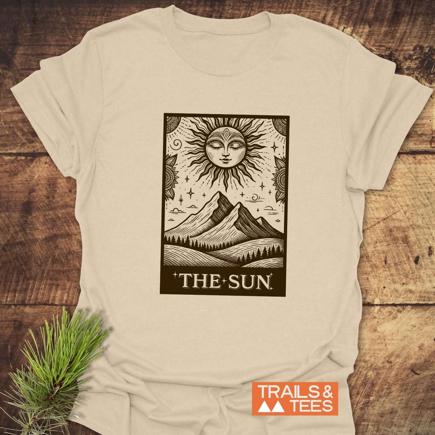 The Sun Tarot T-Shirt featuring a black, tarot-style sun illustration on light-beige fabric, highlighting outdoor adventure spirit with durable, comfortable design.