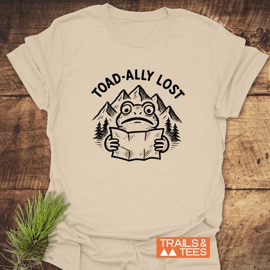 Toad-ally Lost T-Shirt featuring a black-ink toad illustration with a map, crafted from soft cotton, ideal for outdoor enthusiasts.