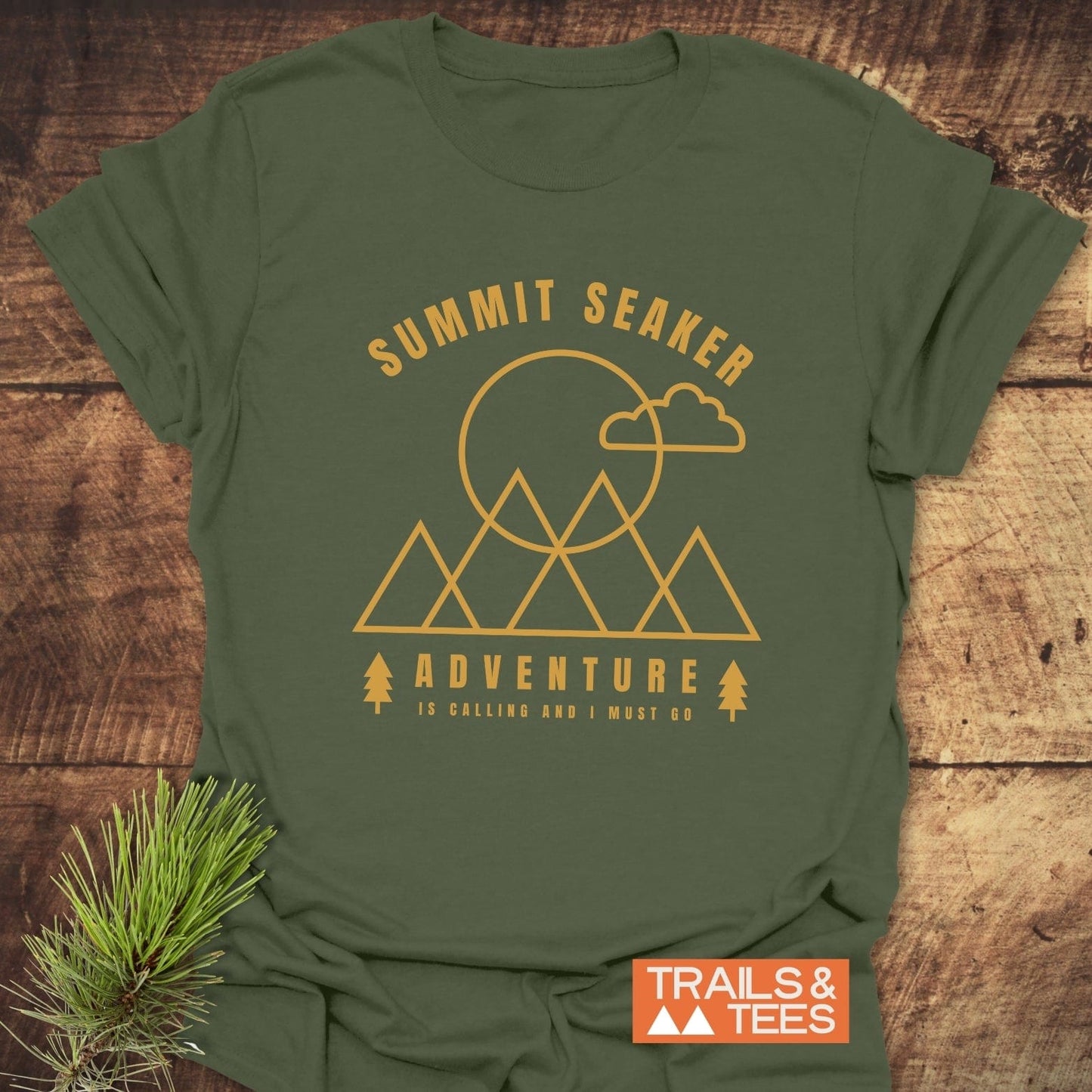 Summit Seaker T-Shirt features a mountain graphic with sun and cloud, mustard-yellow print on olive-green, embodying adventure and outdoor spirit, crafted for comfort and durability.