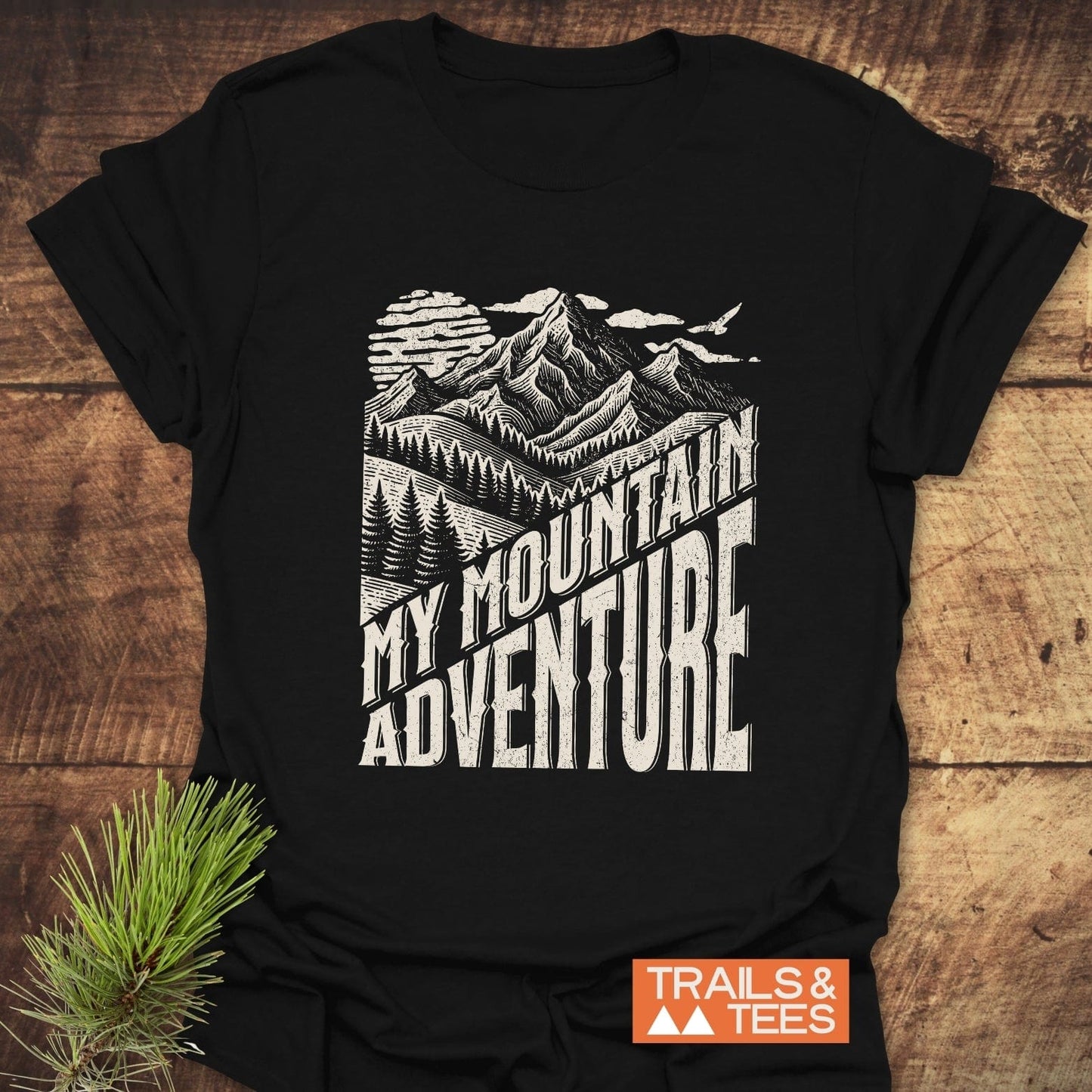 My Mountain Adventure T-Shirt features a stylized mountain print. Made from soft ring-spun cotton, it offers durable comfort for outdoor enthusiasts.