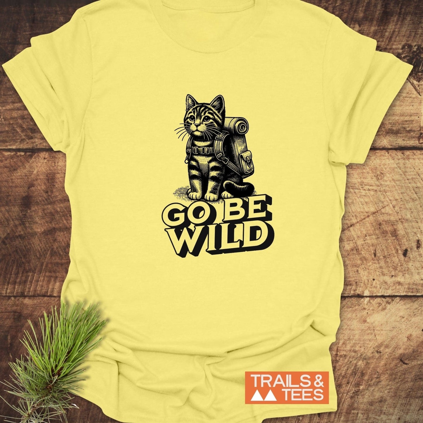 Go Be Wild Cat T-Shirt featuring a kitten with a backpack and slogan, crafted from soft cotton for comfort and durability, ideal for outdoor enthusiasts.