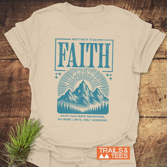 Faith Moves Mountains T-Shirt with “Matthew 17:20” and mountain graphic in teal, showcasing durable, soft cotton for outdoor enthusiasts. Includes Trails & Tees logo.