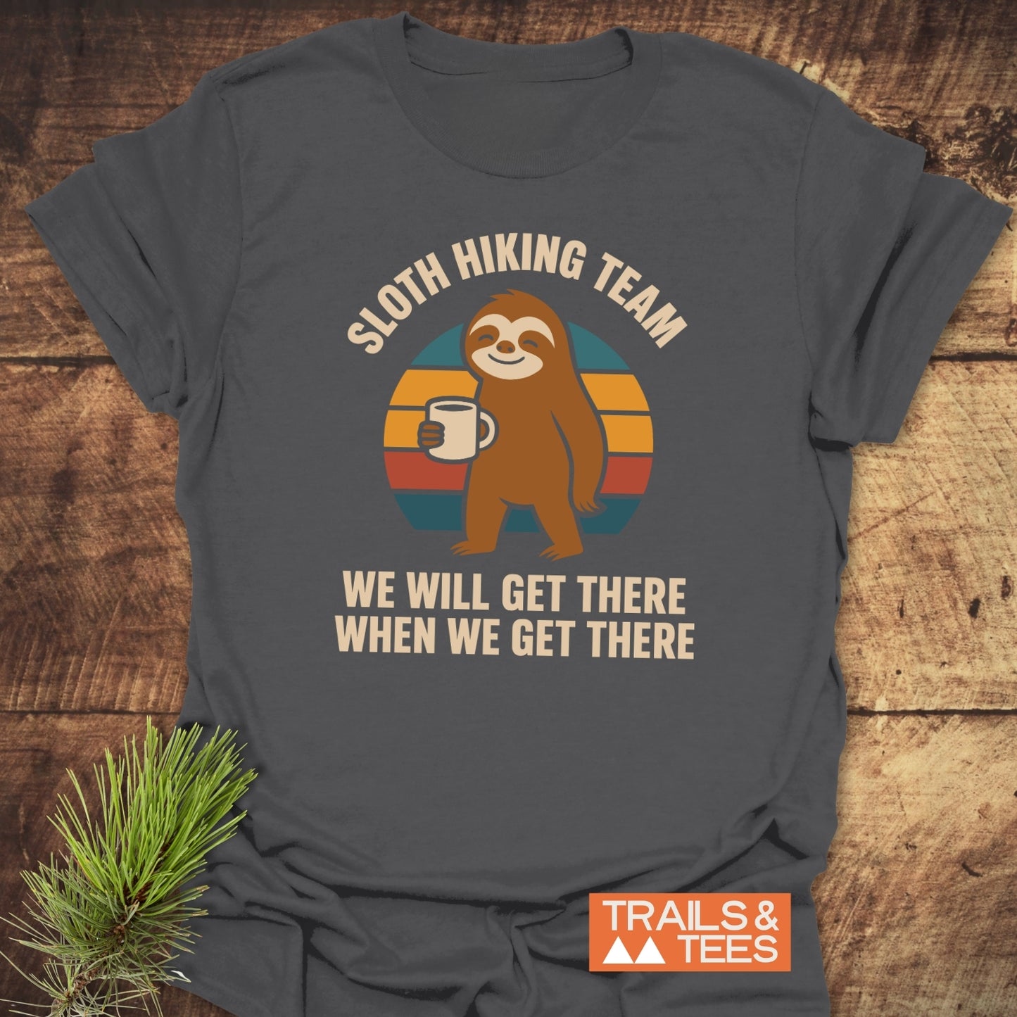 Sloth Hiking Team T-Shirt features a cartoon sloth with coffee, retro sunset, and motivational text, showcasing comfort and style for outdoor enthusiasts.