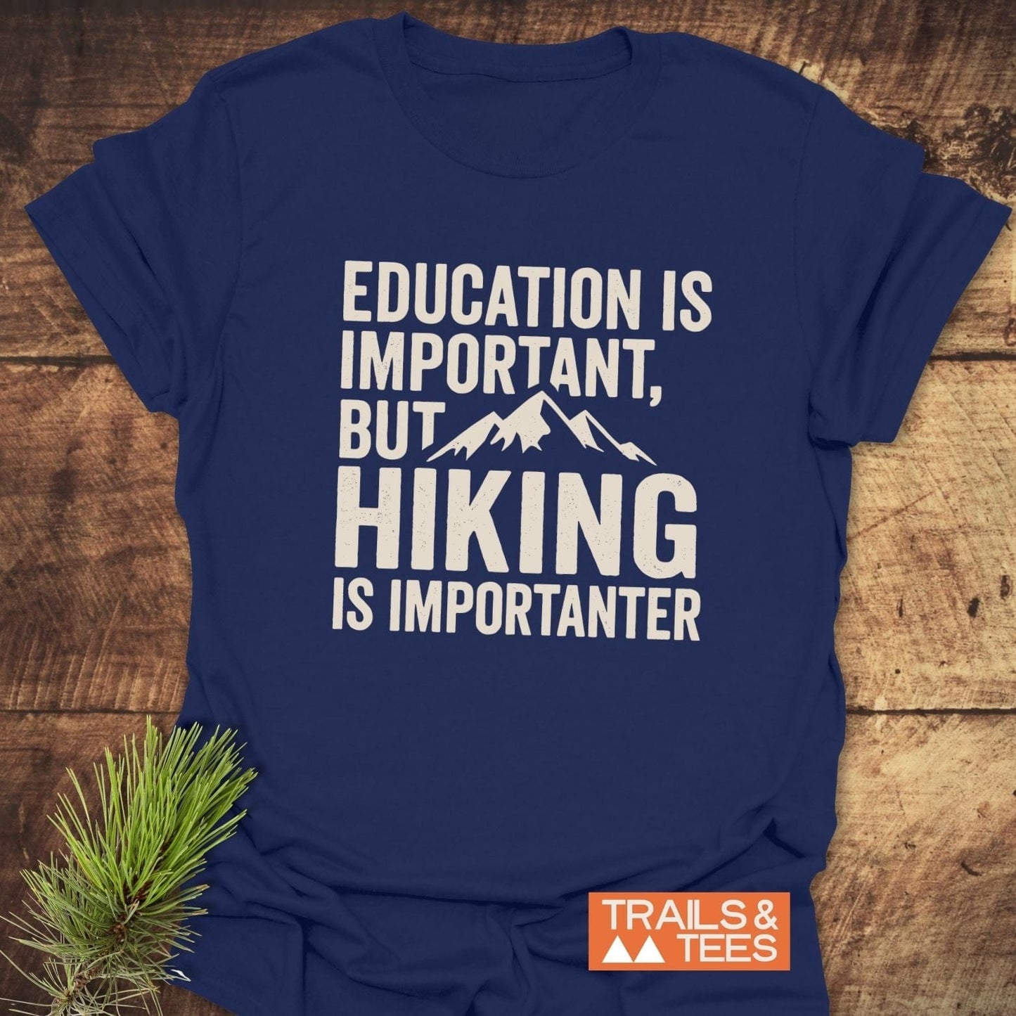 Navy-blue Education Is Important T-Shirt featuring a mountain graphic and slogan, perfect for outdoor enthusiasts. Made from soft, pre-shrunk cotton for comfort and durability.