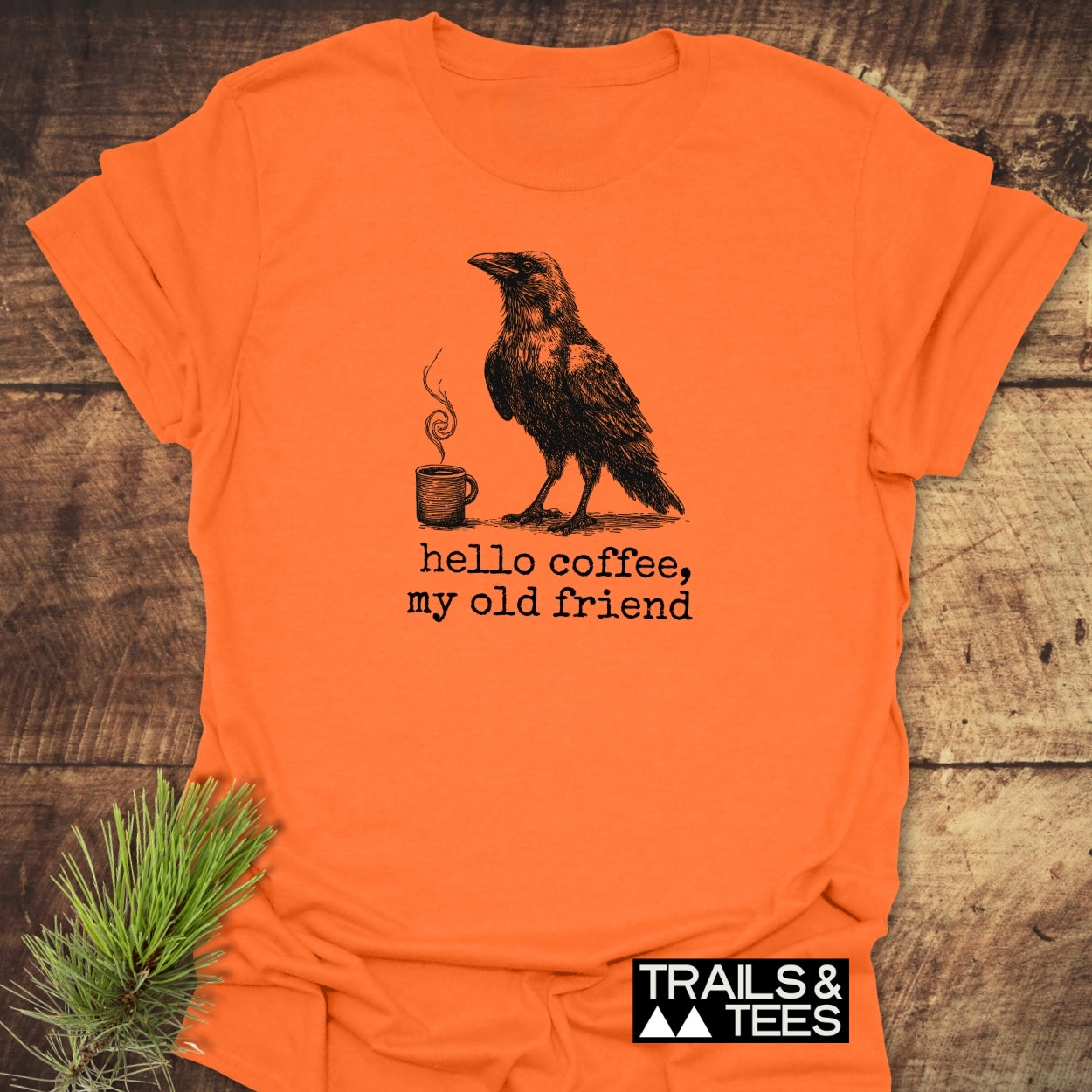 Hello Coffee Funny T-Shirt featuring a crow and coffee mug illustration, typewriter-style text, crafted from soft cotton, perfect for outdoor enthusiasts.
