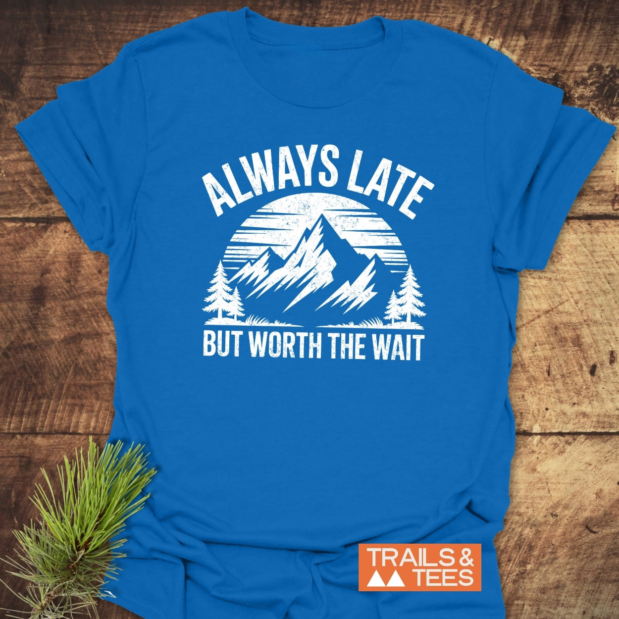 Always Later Funny T-Shirt featuring a distressed mountain graphic with ALWAYS LATE slogan, tailored for comfort and adventure. Includes Trails & Tees logo.