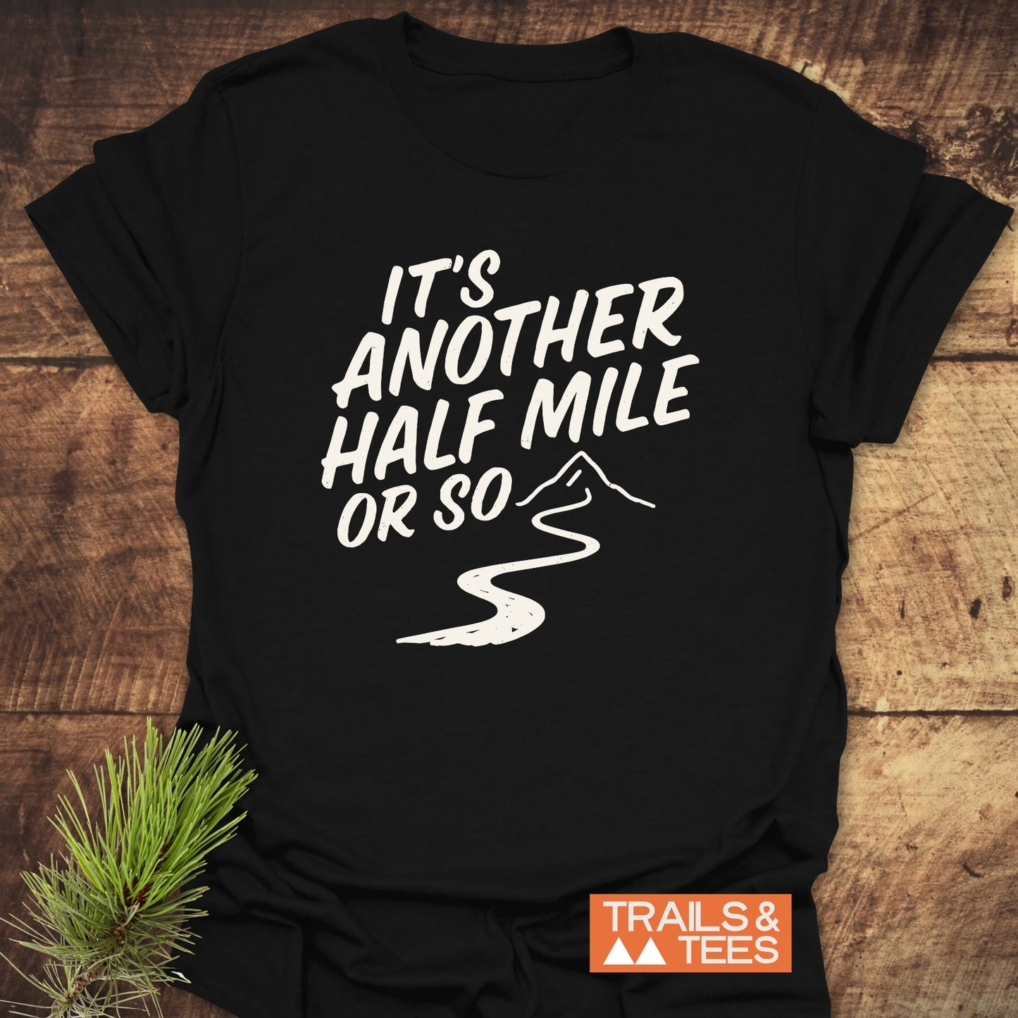 Half Mile Funny T-Shirt featuring a mountain path graphic and slogan. Made from soft cotton for outdoor comfort, with durable prints and a reliable fit.