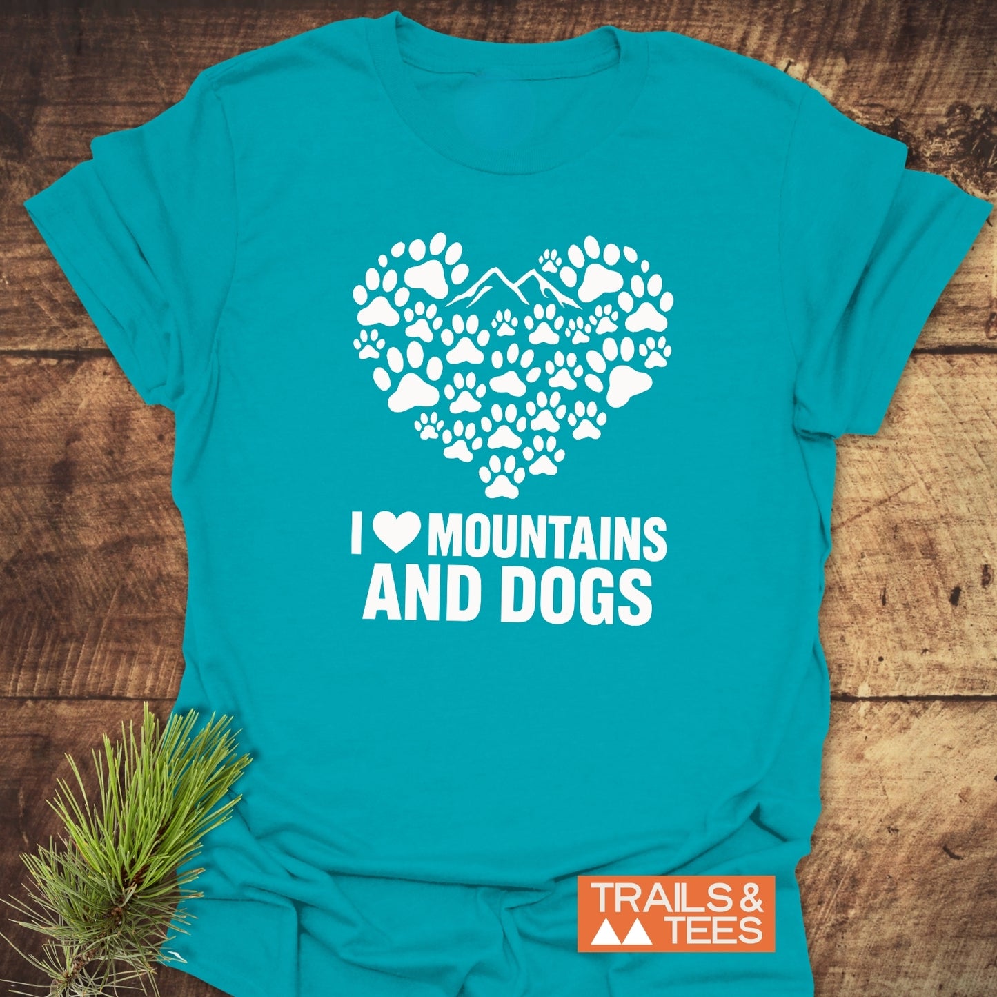 Paw Heart Dog Lover T-Shirt with mountain graphic and slogan, laid flat. Features durable prints, soft cotton, and eco-friendly production by Trails & Tees.