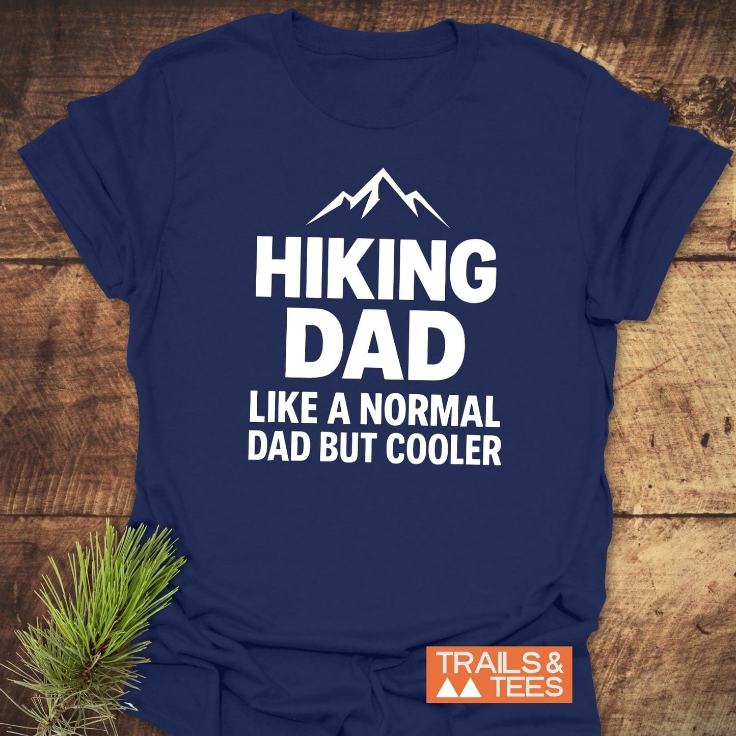 Navy-blue Hiking Dad T-shirt with mountain icon, emphasizing outdoor adventure. Features soft cotton, durable prints, and eco-friendly design from Trails & Tees.