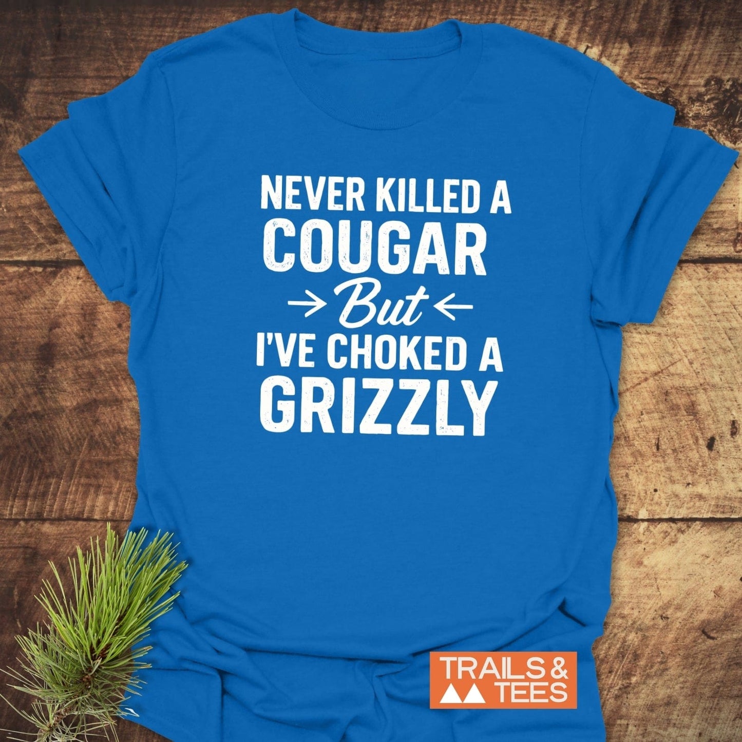Never Killed A Cougar T-Shirt with bold slogan on soft, lightweight cotton, showcasing outdoor spirit. Features durable print, taped shoulders, and no side seams.