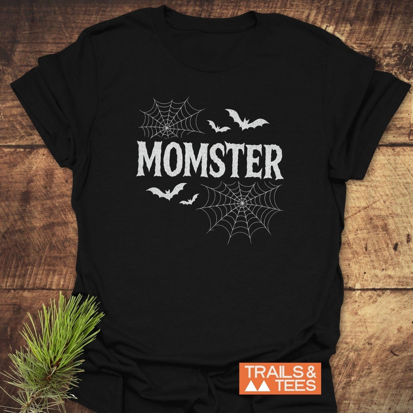 Black MOMSTER T-shirt with horror-style font, spiderwebs, bats; features soft ring-spun cotton and durable prints, designed for outdoor adventures.