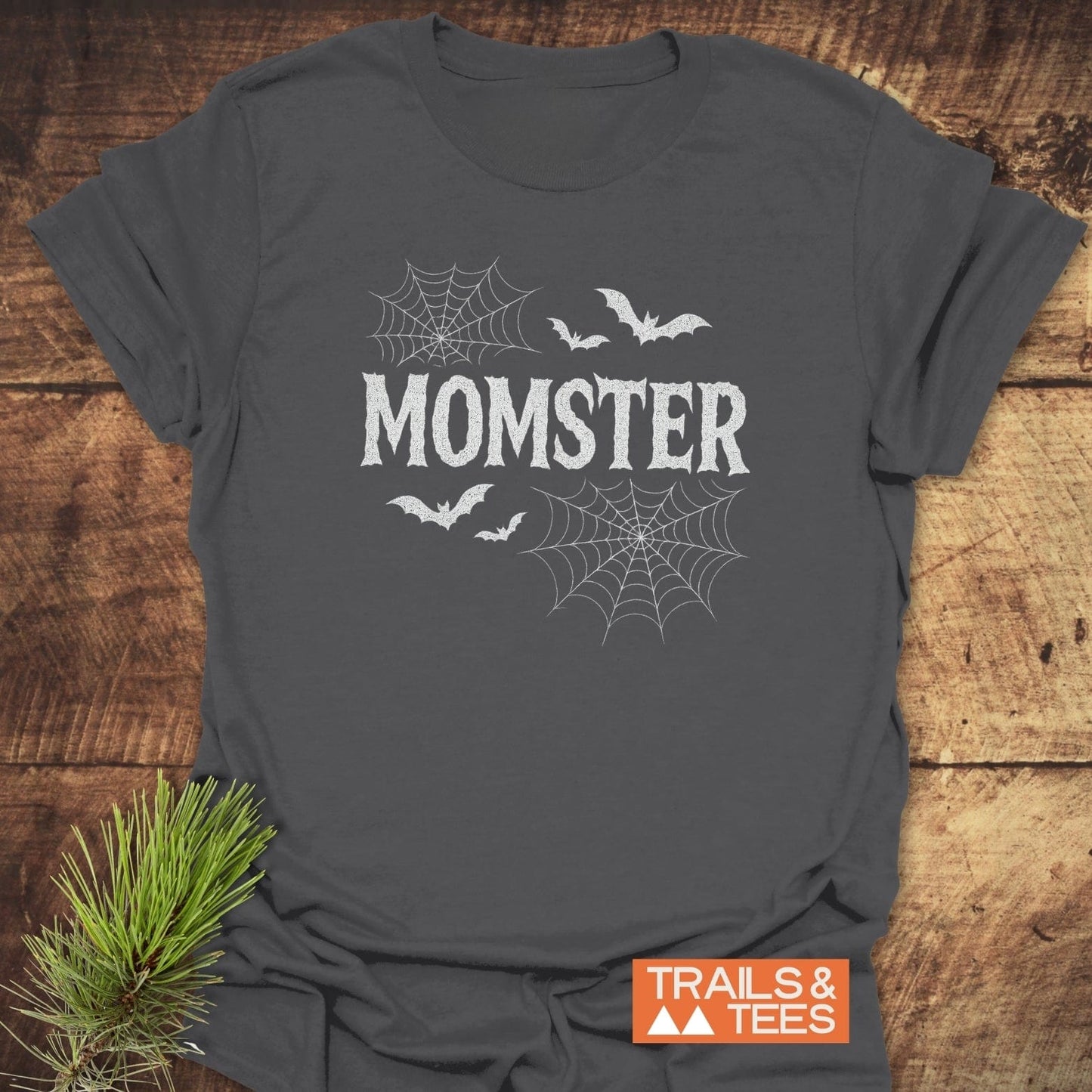 MOMSTER Halloween T-Shirt features distressed white lettering with spider-web and bat designs, crafted from soft ring-spun cotton for comfort and durability.