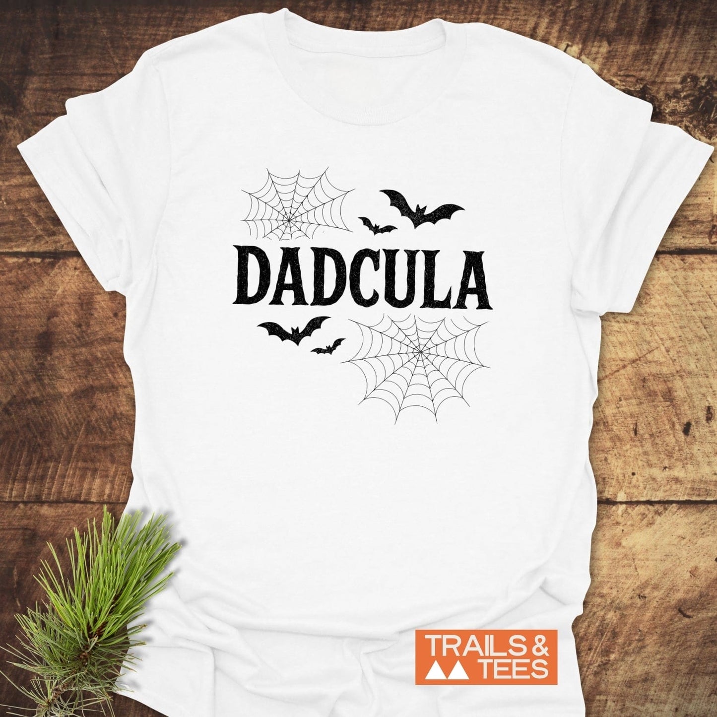 Dadcula Halloween T-Shirt with bats and cobwebs, featuring a spooky font. Made from soft cotton, it offers comfort and durability for outdoor adventures.