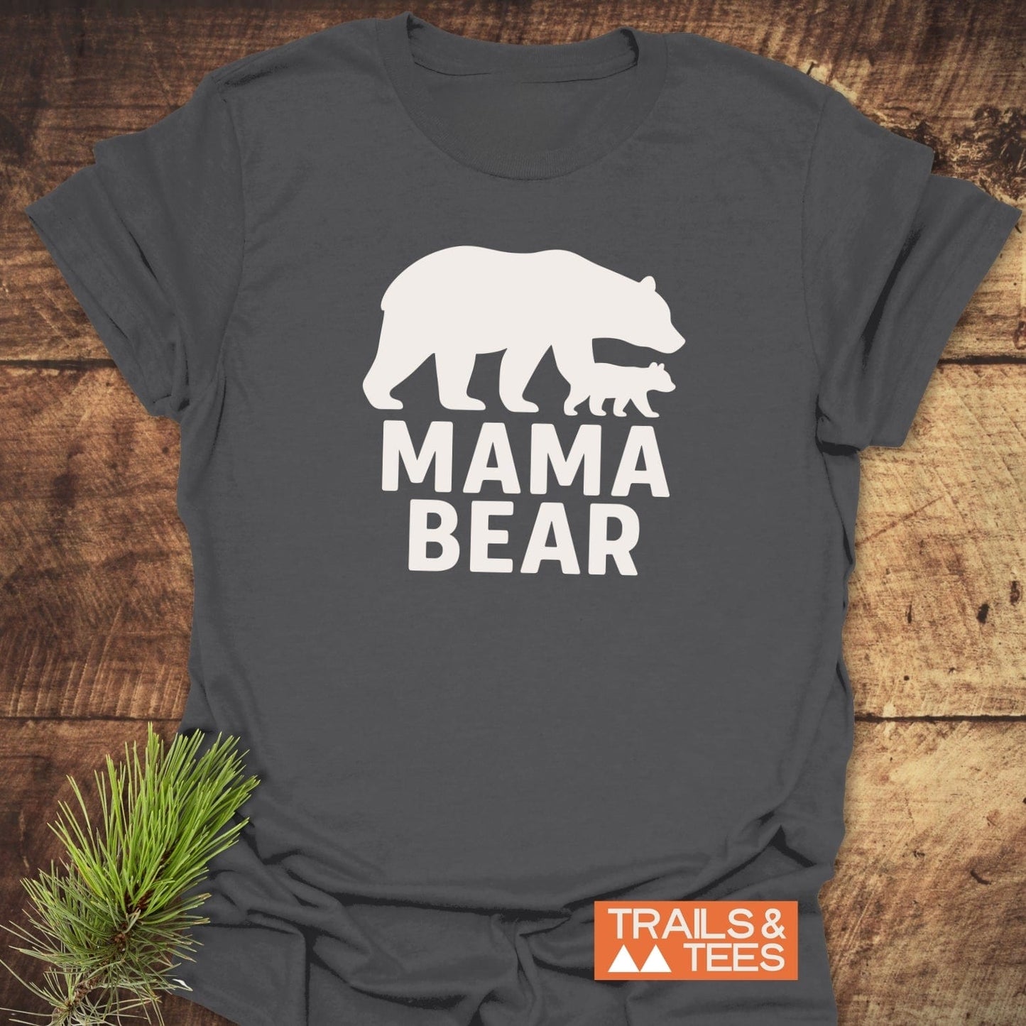 Mama Bear T-Shirt featuring a bear and cub silhouette, emphasizing outdoor adventure, crafted from soft cotton with durable print, rustic pine accent included.