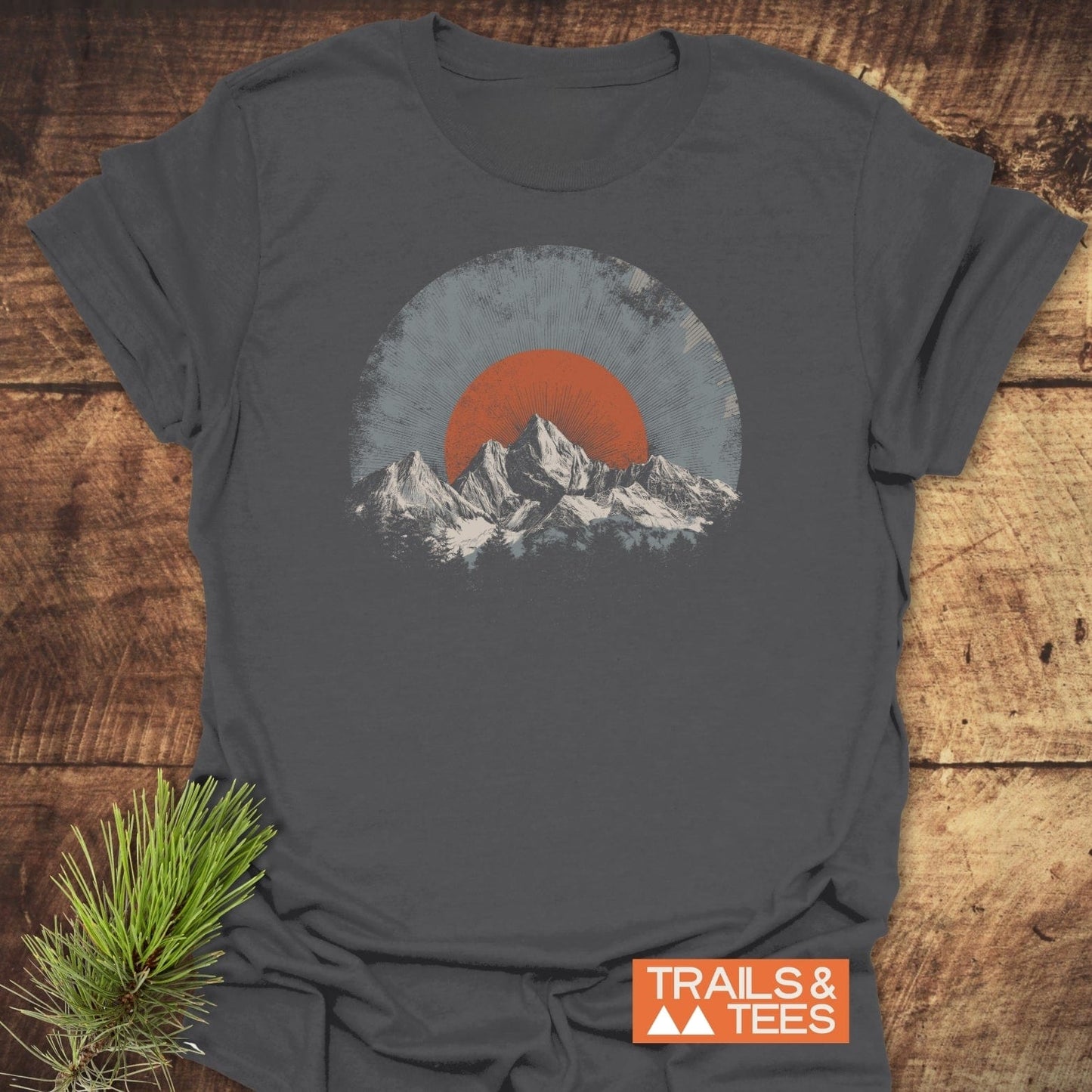 Rocky Mountains Sunset T-Shirt: Charcoal tee with stylized mountain and sun/moon motif. Soft, ring-spun cotton, pre-shrunk, durable print, and eco-friendly production.