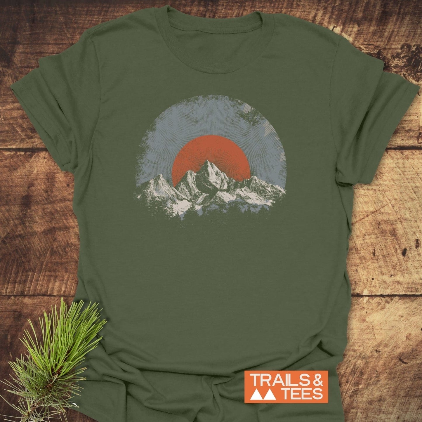 Rocky Mountains Sunset T-Shirt featuring a retro mountain graphic. Made from soft cotton, it embodies outdoor adventure spirit with durable prints and a reliable fit.