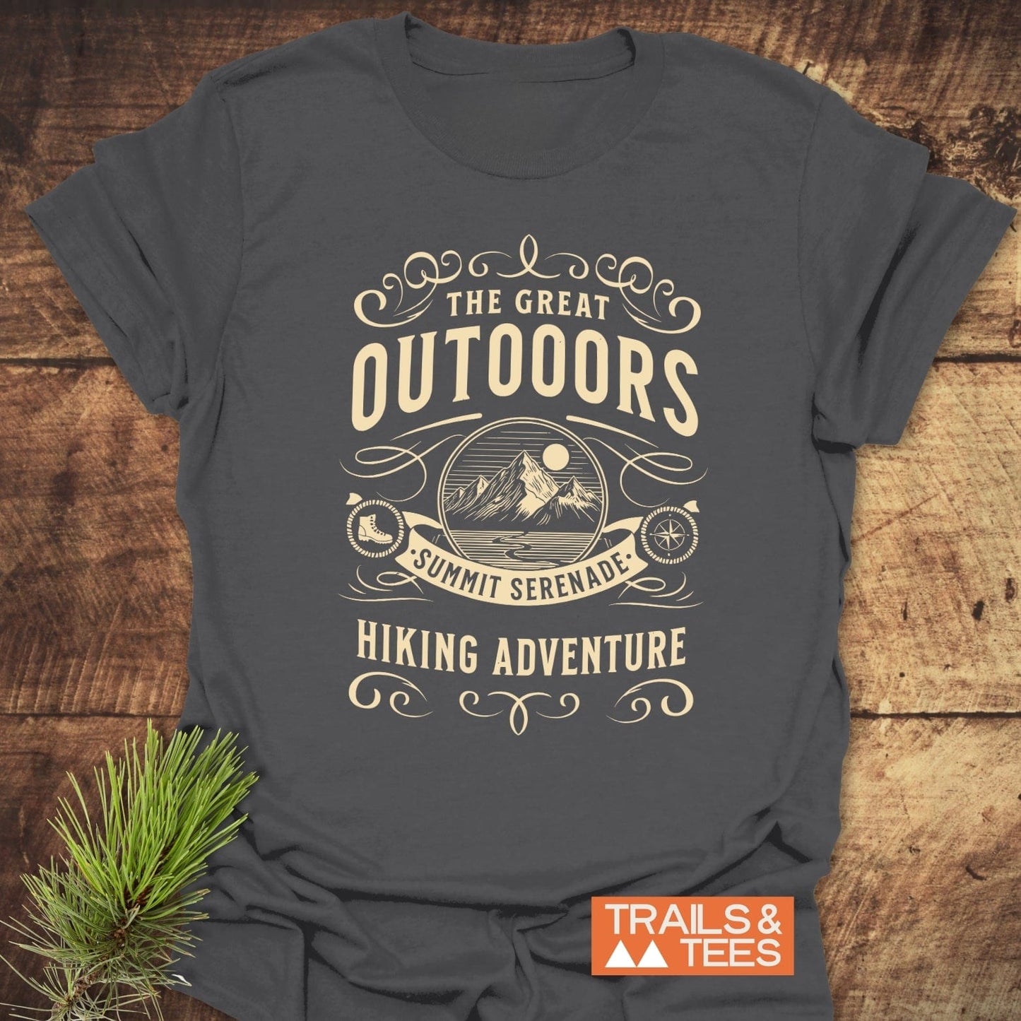 The Great Outdoors T-Shirt with mountain badge, hiking motifs, and Summit Serenade text, showcasing durable design and outdoor spirit.