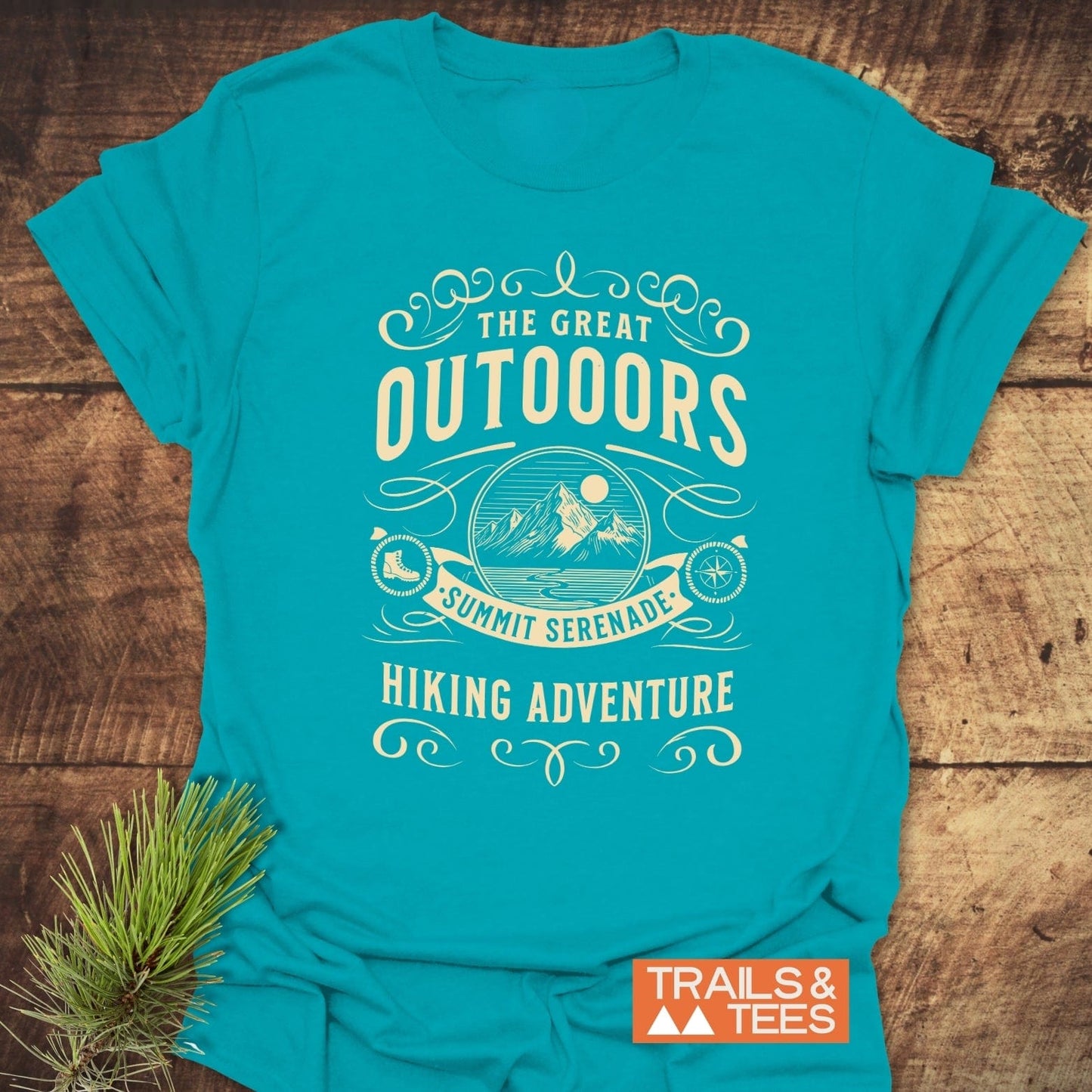 The Great Outdoors T-Shirt features a vintage mountain graphic and adventurous text, crafted from soft cotton for comfort and durability, ideal for nature enthusiasts.