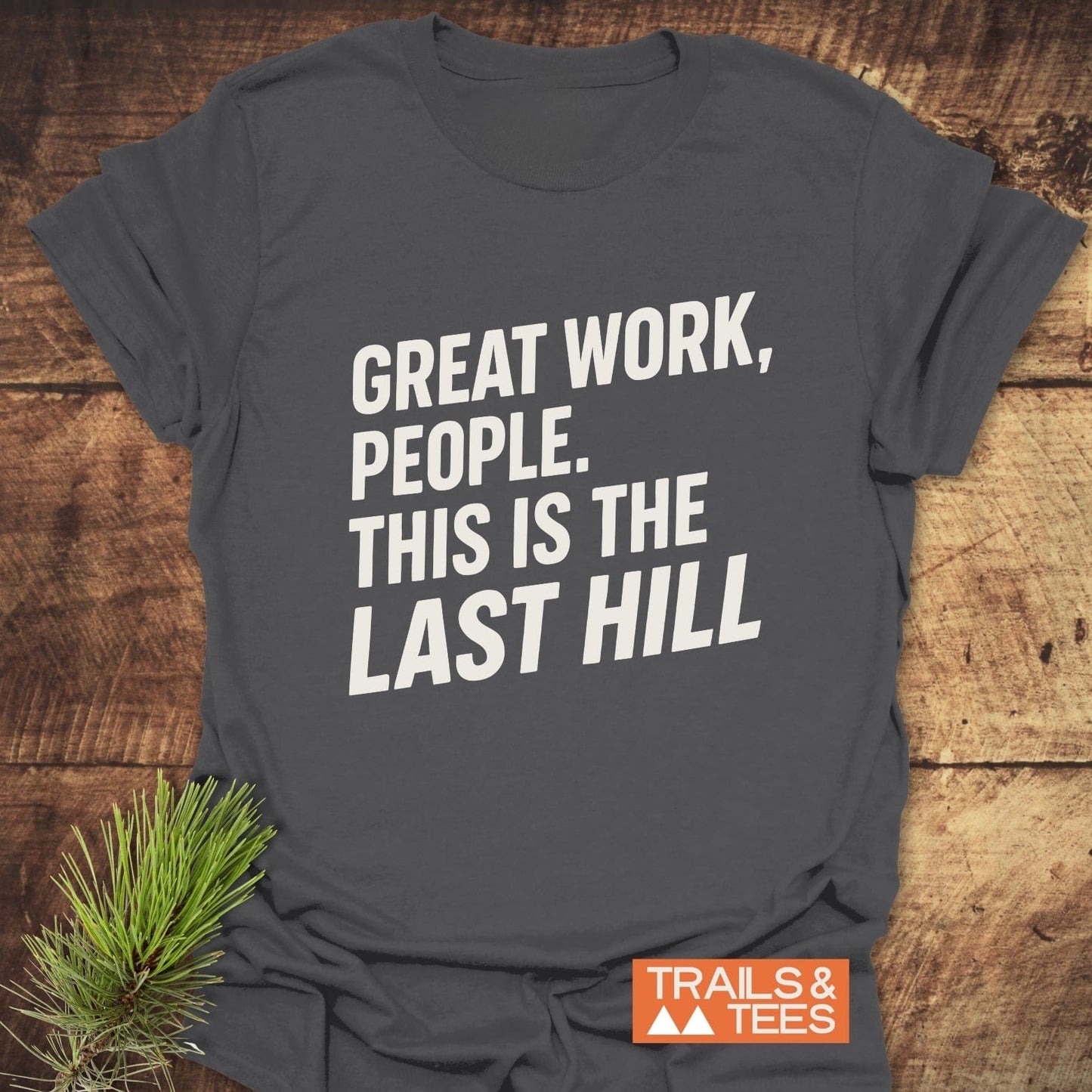 Great Work Funny T-Shirt on wooden surface; white text and Trails & Tees logo, showcasing trail-tested comfort and outdoor spirit.