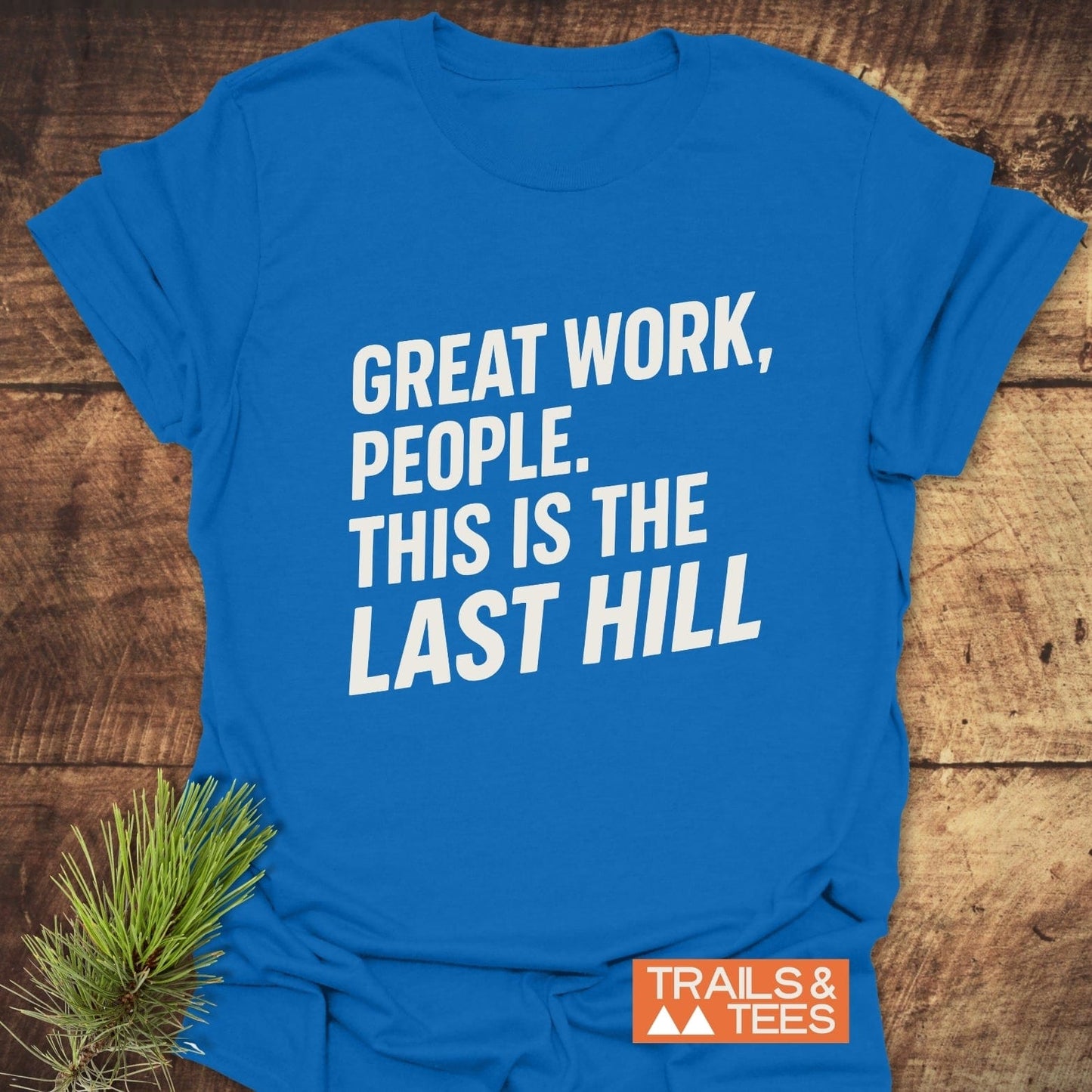 Bright blue Great Work Funny T-Shirt with bold white text, laid flat. Features durable DTF prints, taped shoulders, and an orange “TRAILS & TEES” logo.