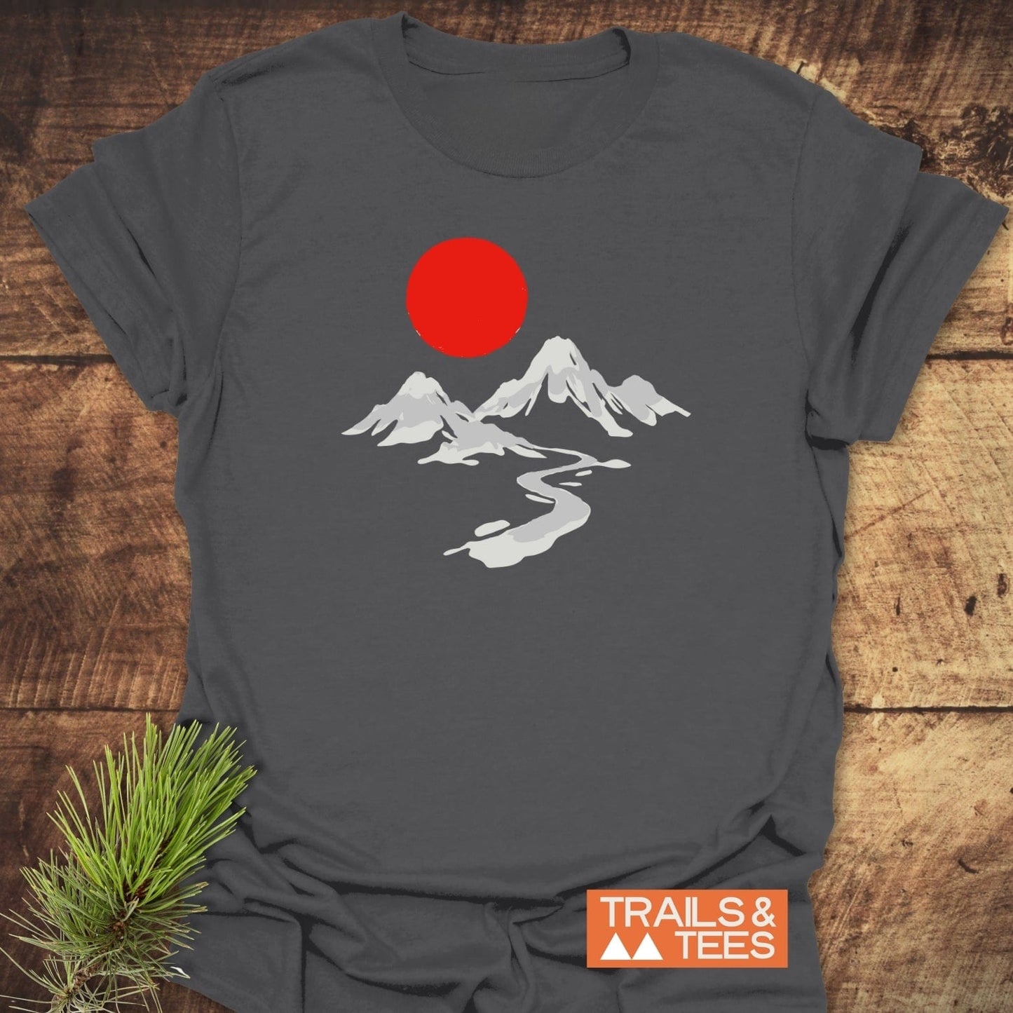 Crimson Sun T-Shirt featuring white mountain peaks and red sun graphic, crafted from soft ring-spun cotton, ideal for outdoor enthusiasts.