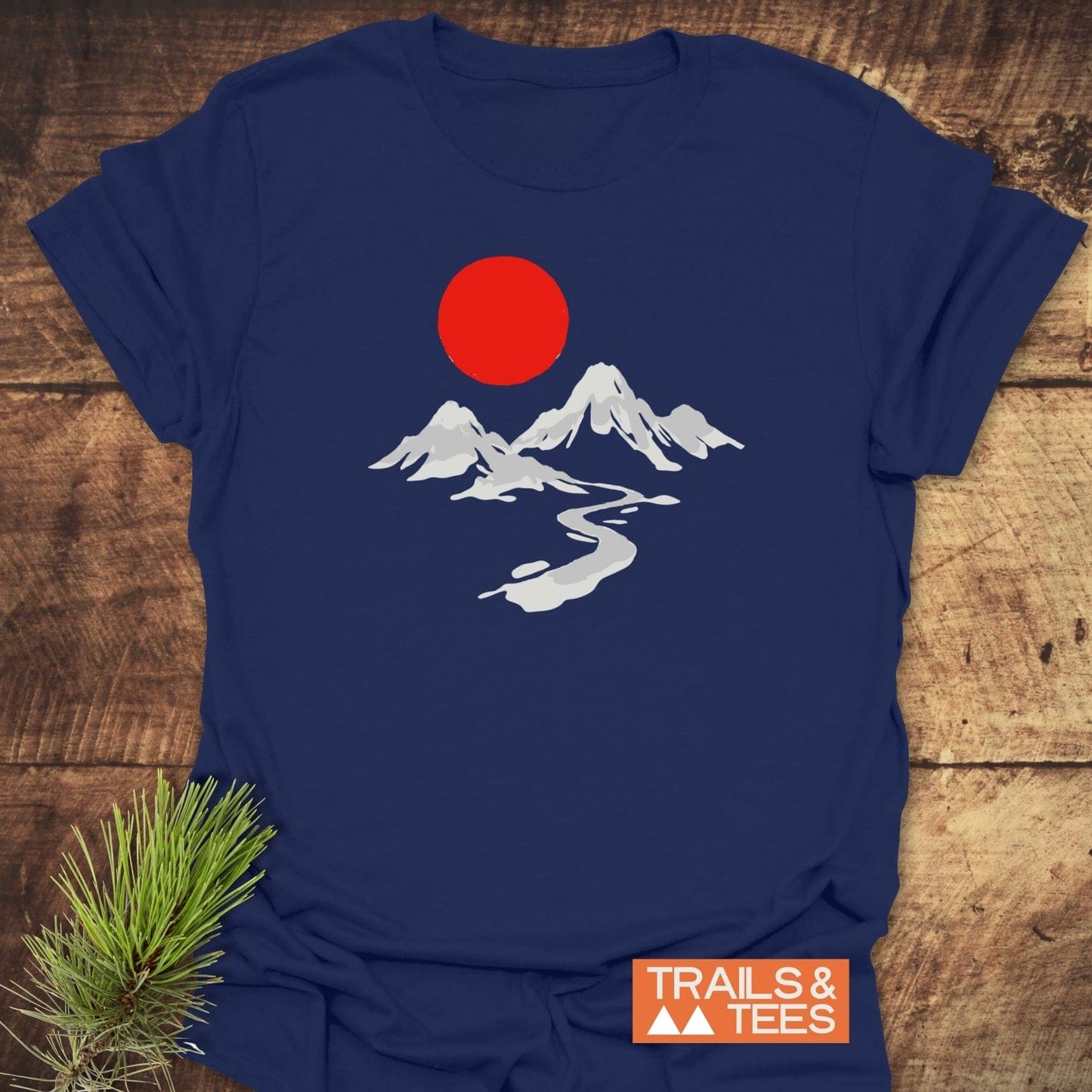 Crimson Sun T-Shirt featuring a white mountain scene and red sun on navy, crafted from soft cotton for comfort and durability, ideal for outdoor enthusiasts.