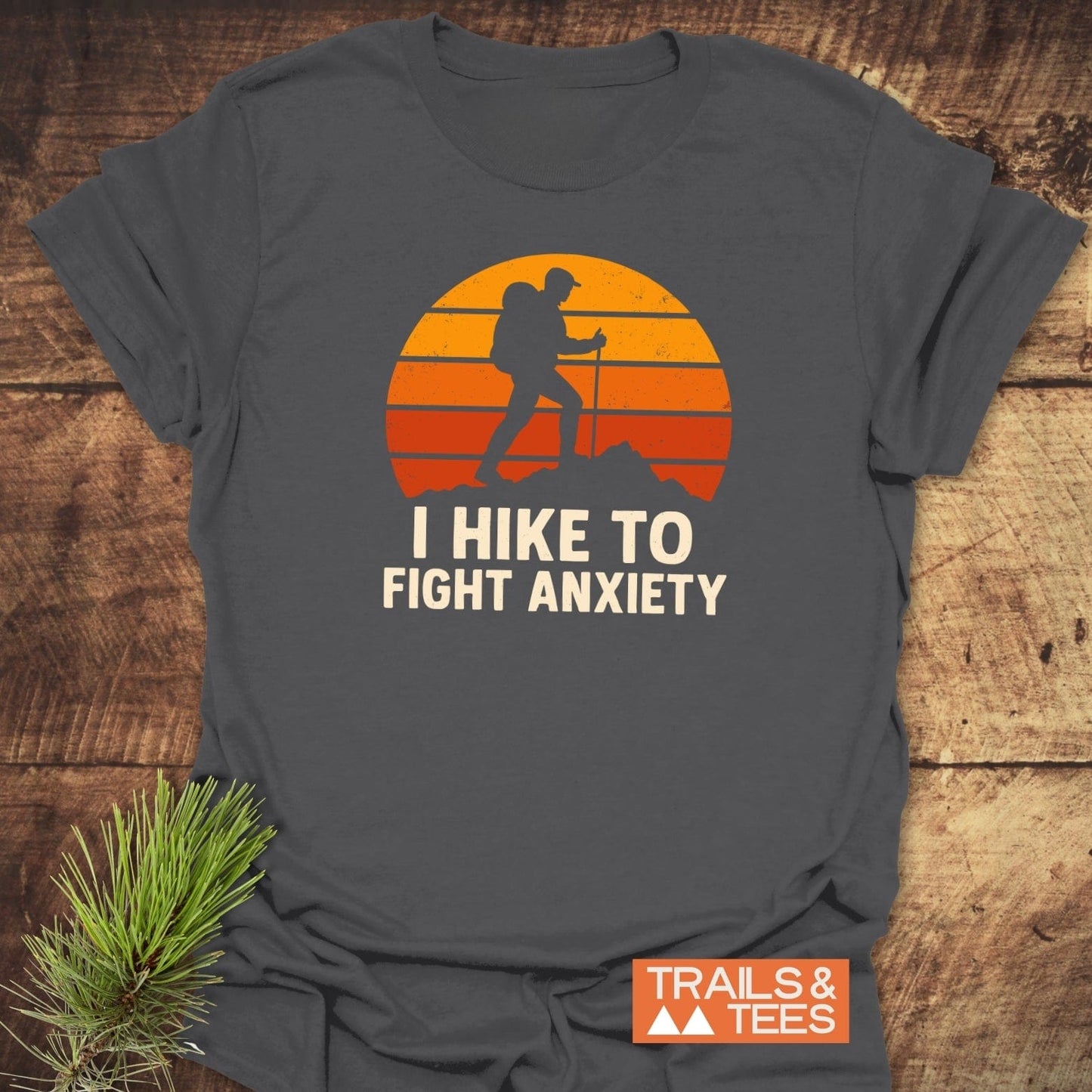 Hike To Fight Anxiety T-Shirt features a hiking silhouette against an orange sunset with slogan, crafted from soft cotton for comfort and durability.