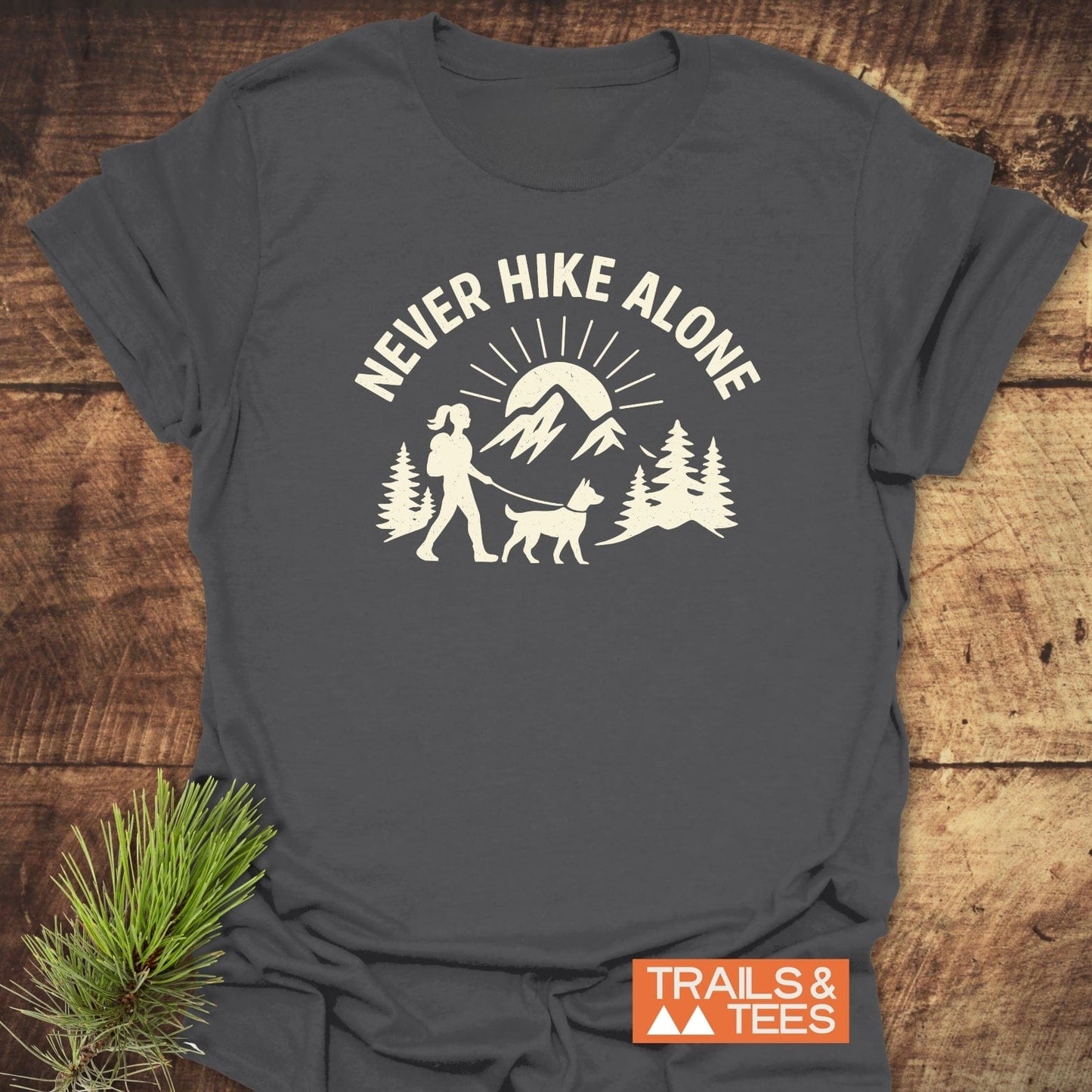 Never Hike Alone Dog Mom T-Shirt, featuring durable hiking graphic, soft ring-spun cotton, taped shoulders, and pre-shrunk fit for lasting outdoor comfort.