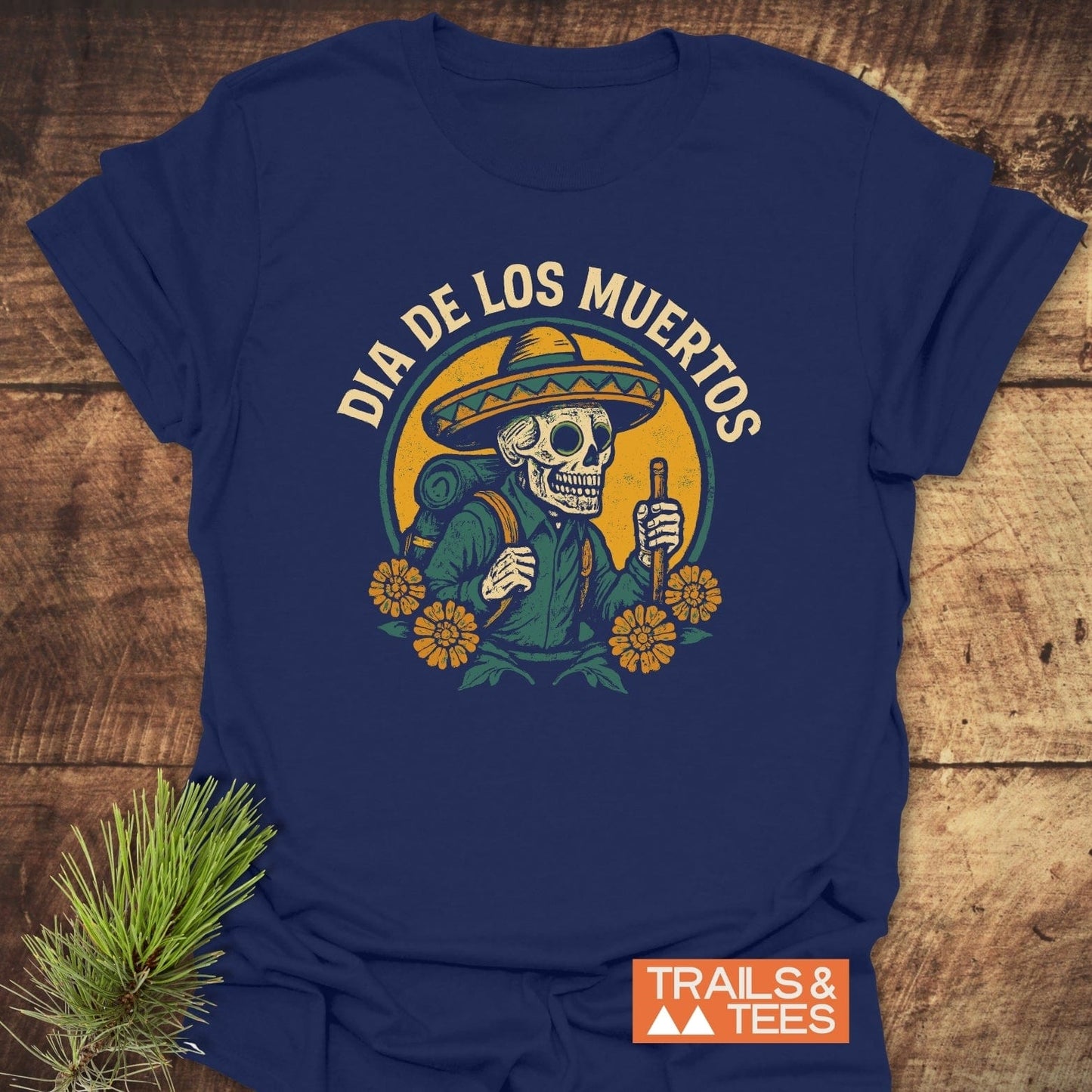 Navy-blue Hiking Skull T-Shirt featuring a Day-of-the-Dead skeleton with sombrero, marigolds, and DIA DE LOS MUERTOS text, showcasing durable, comfortable, adventure-ready design.