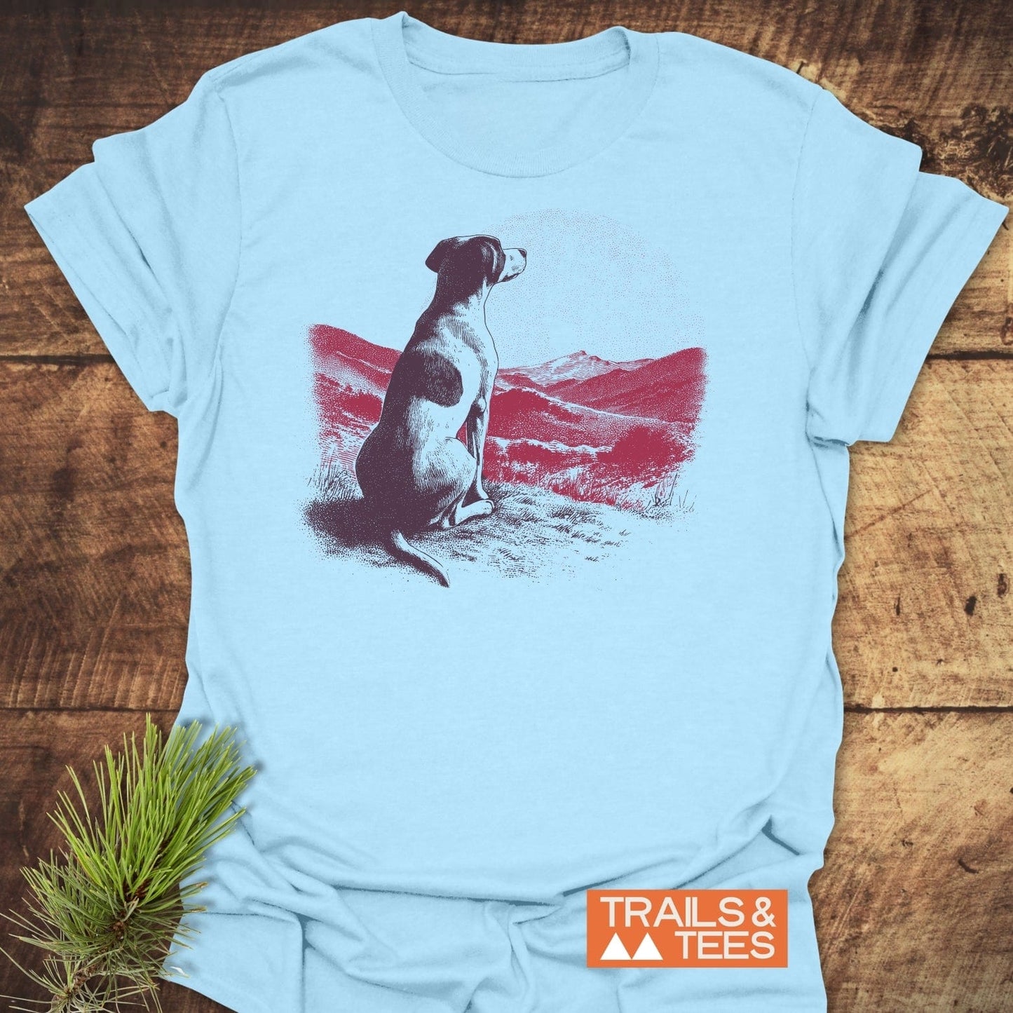 Mountains and Dog T-Shirt featuring a graphic of a dog overlooking a red mountain landscape, crafted from soft cotton for comfort and durability, ideal for outdoor enthusiasts.