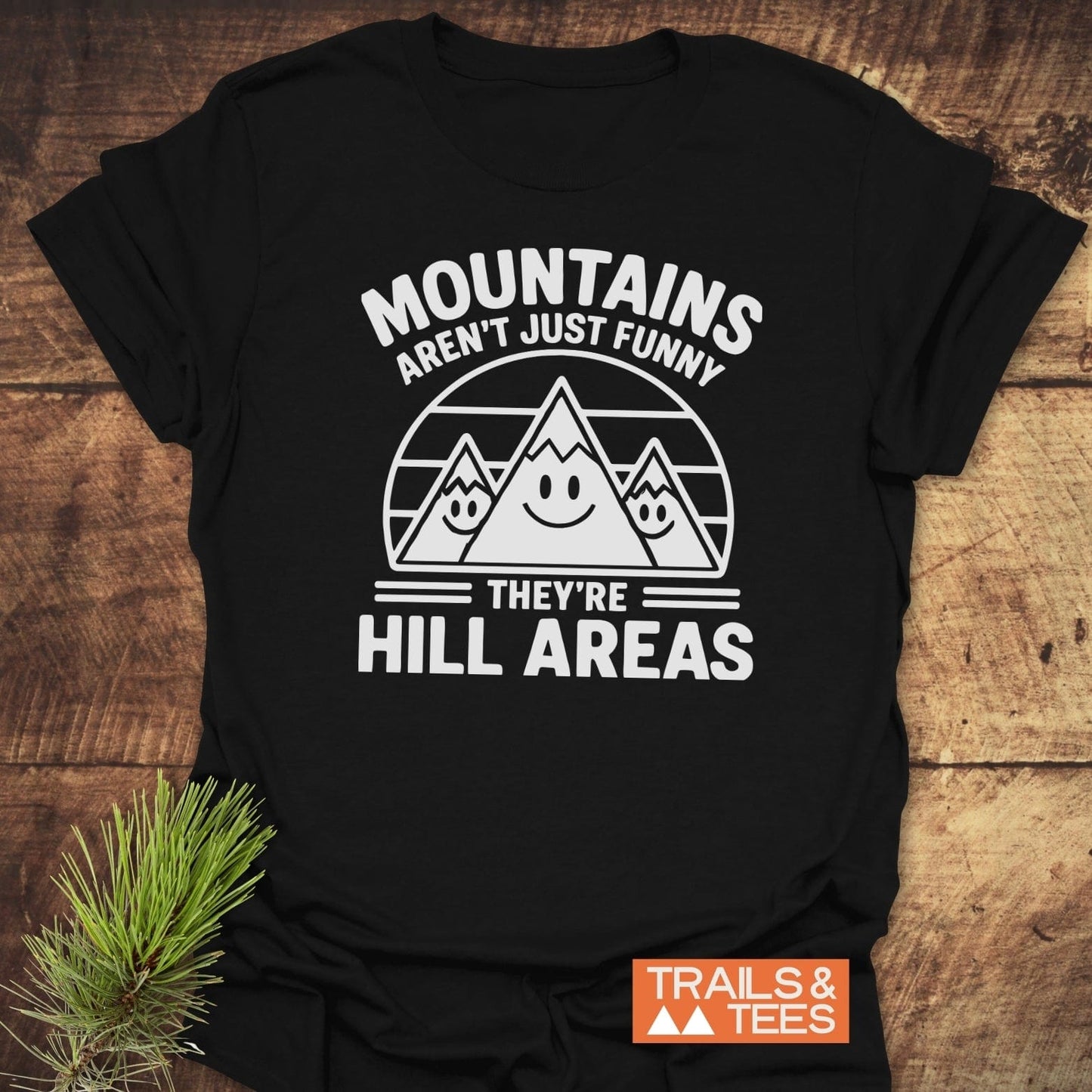 Copy of I love Mountains And Coffee T-Shirt with cartoon mountains and humorous text, showcasing durable, lightweight cotton design for outdoor enthusiasts.