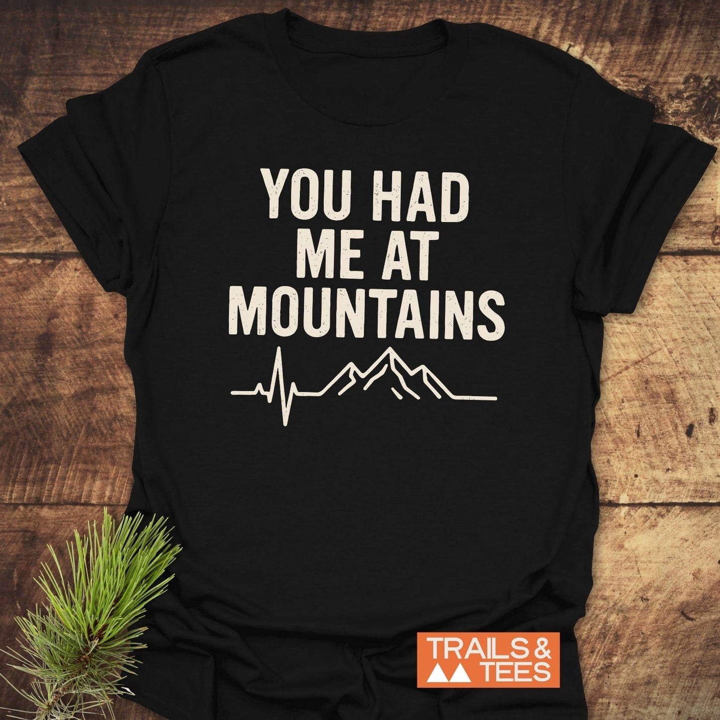 You Had Me At Mountains T-Shirt with EKG and mountain design on black, showcasing outdoor spirit. Features soft, lightweight cotton for comfort and durability.
