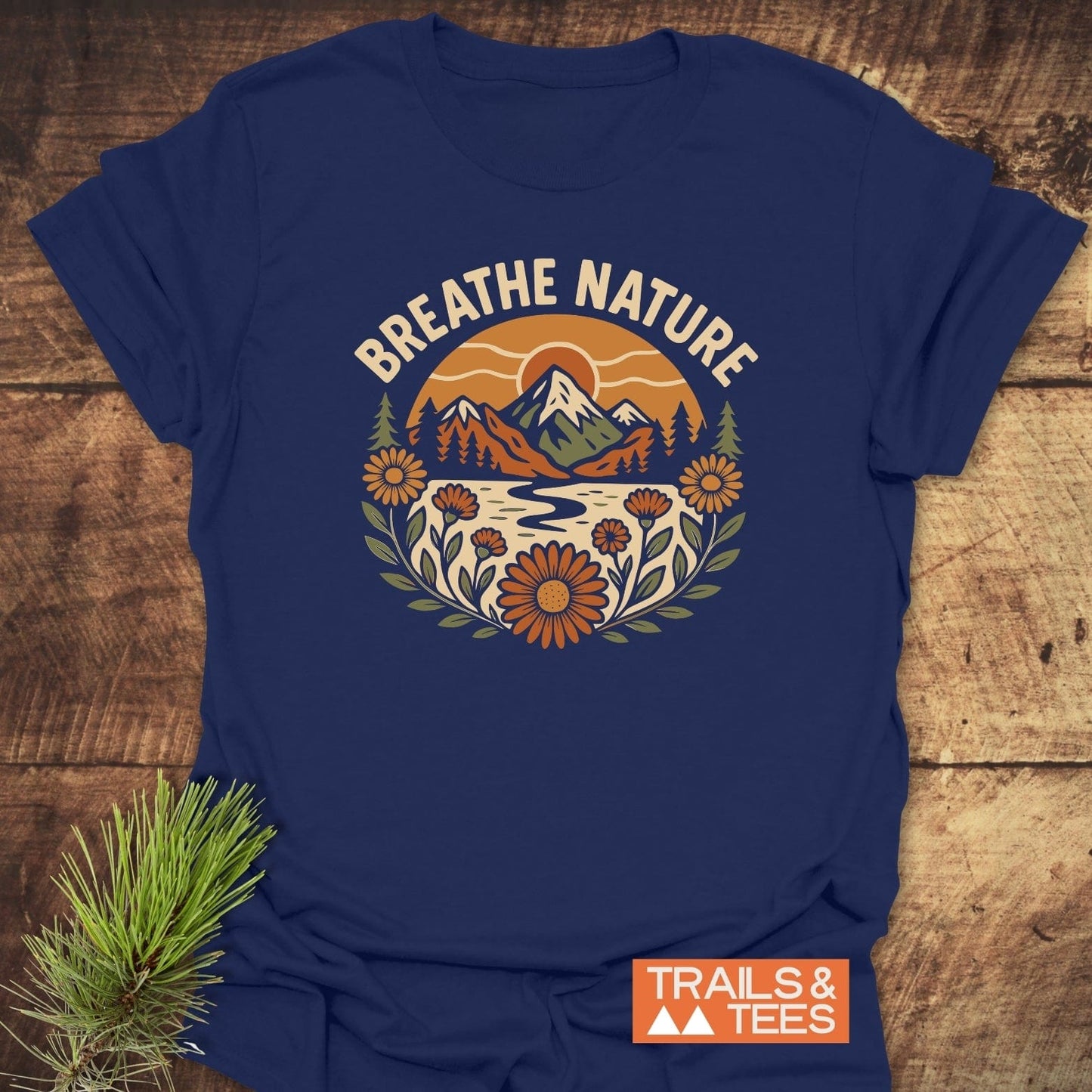 Breathe Nature T-Shirt features a nature scene with mountains and river. Made from soft cotton, it offers comfort and durability.