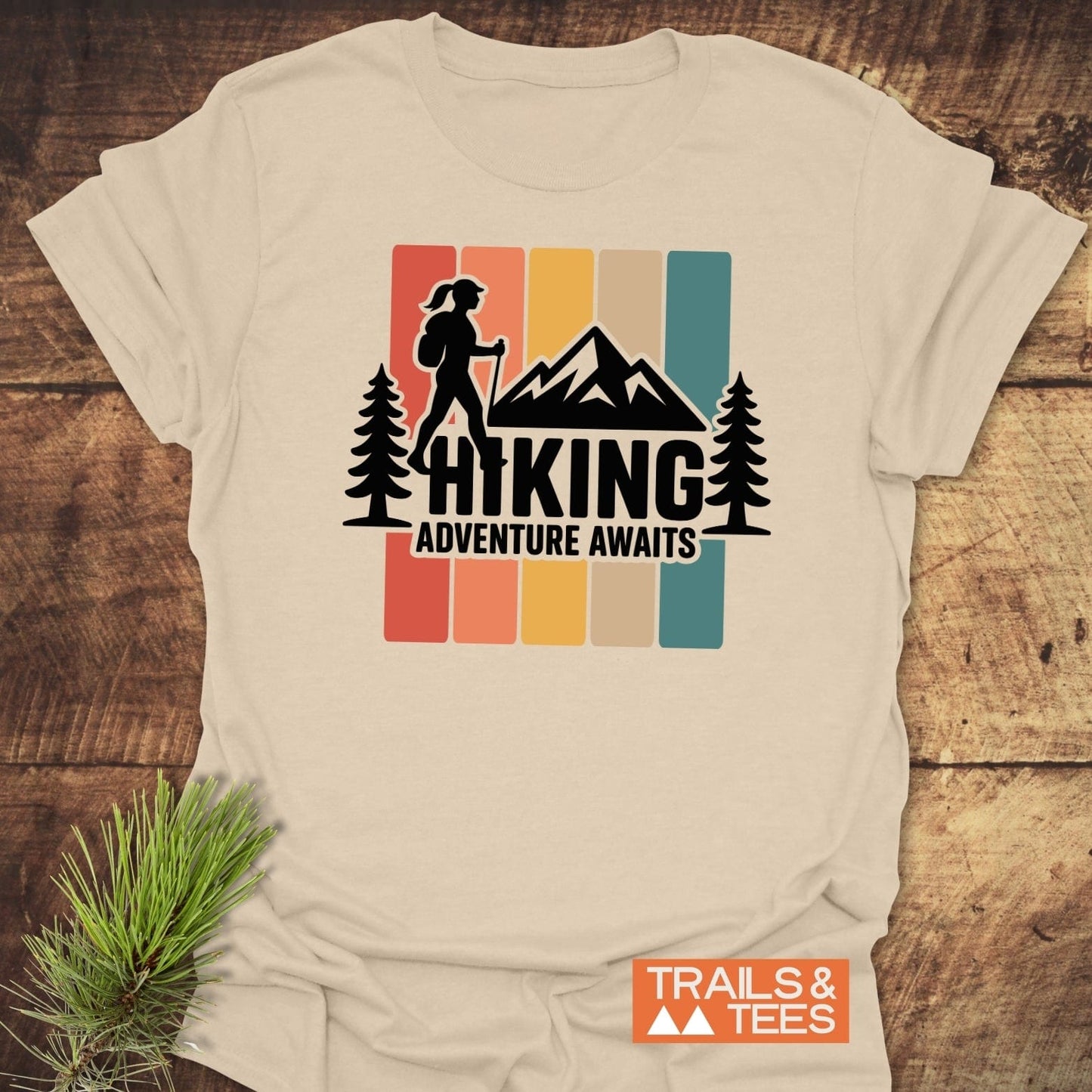 Hiking Girl T-Shirt featuring a retro graphic with a hiker silhouette and slogan HIKING ADVENTURE AWAITS, crafted from soft, durable cotton, ideal for outdoor enthusiasts.