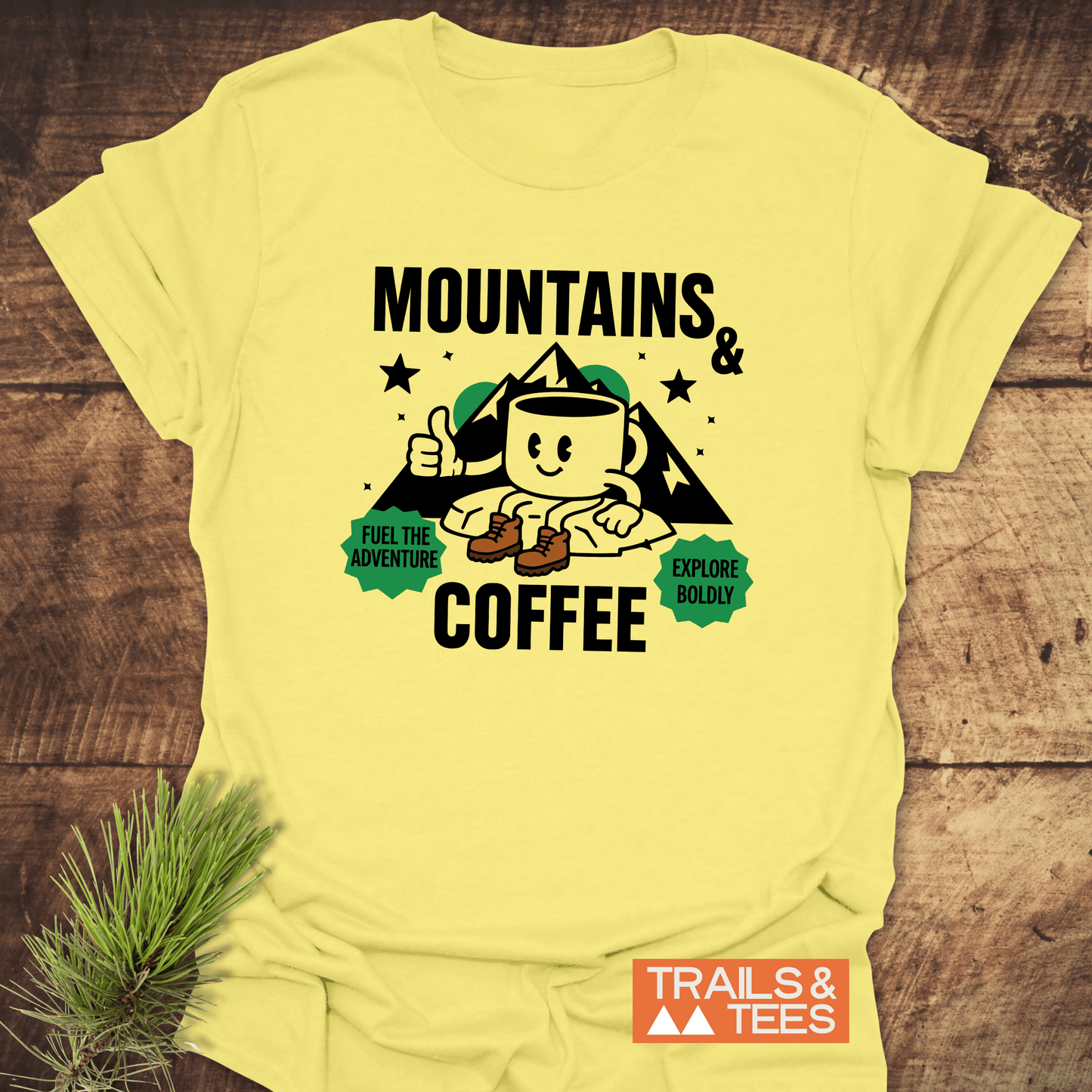 Mountains & Coffee Retro T-Shirt featuring an anthropomorphic coffee mug graphic with hiking boots, mountain peaks, and adventure-themed phrases, ideal for outdoor enthusiasts.