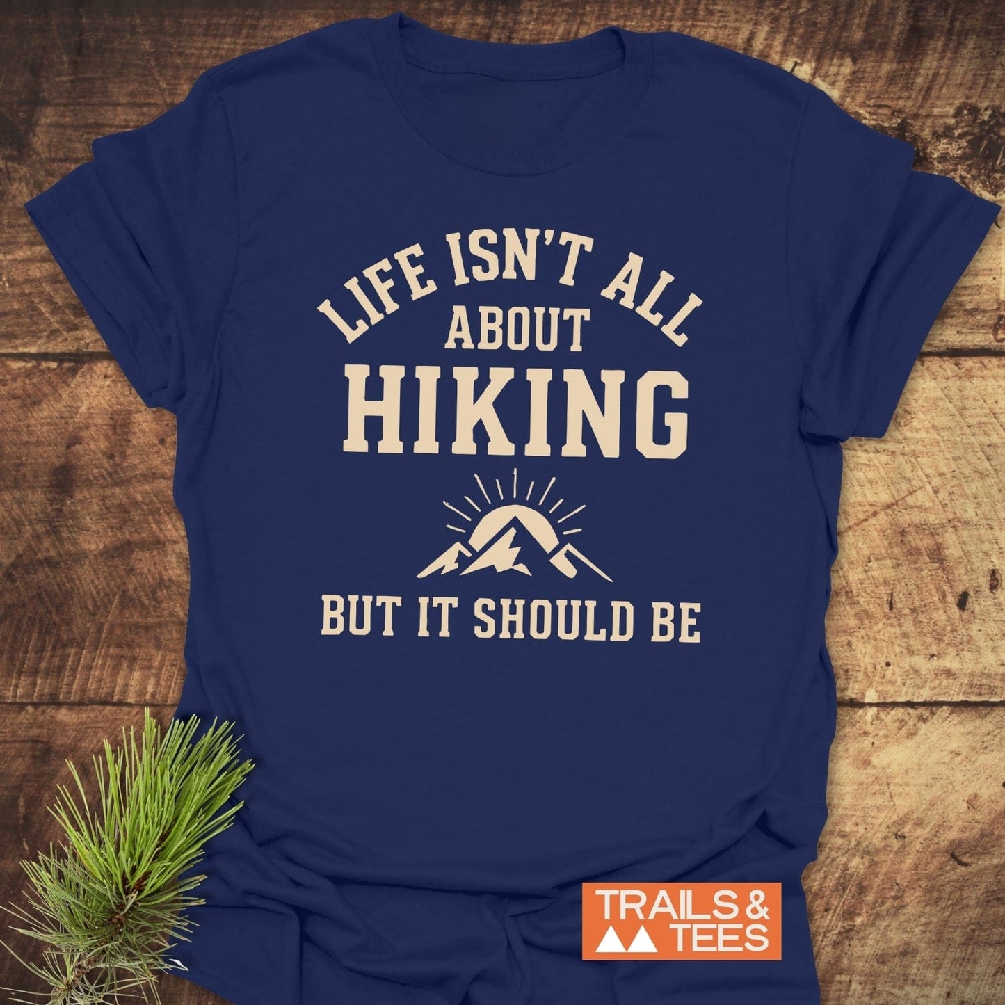 Navy-blue Life Isn't All About Hiking T-shirt with cream lettering and mountain graphic, featuring durable prints and soft ring-spun cotton for outdoor enthusiasts.