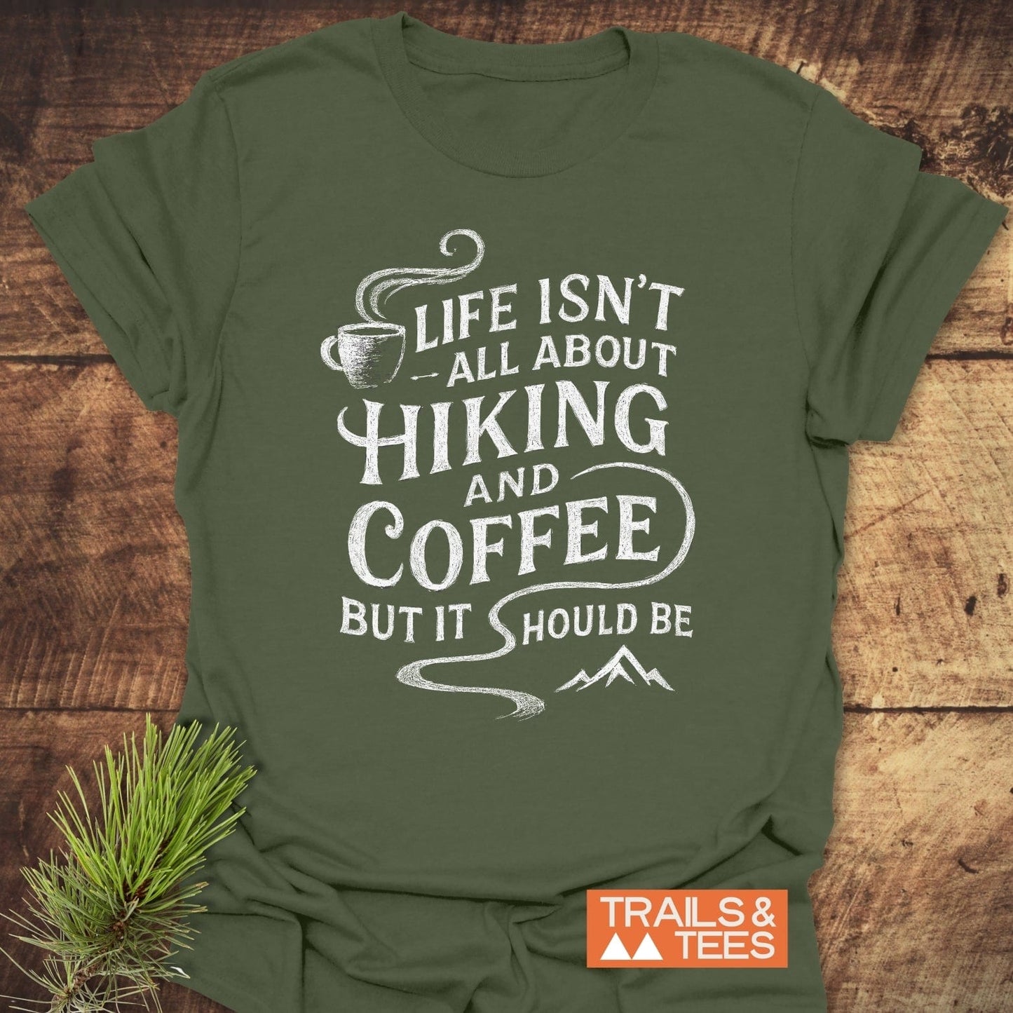 Forest-green Hiking and Coffee T-Shirt with white slogan, mountain, coffee cup graphics; brand Trails & Tees. Crafted from soft, lightweight cotton for everyday adventure.