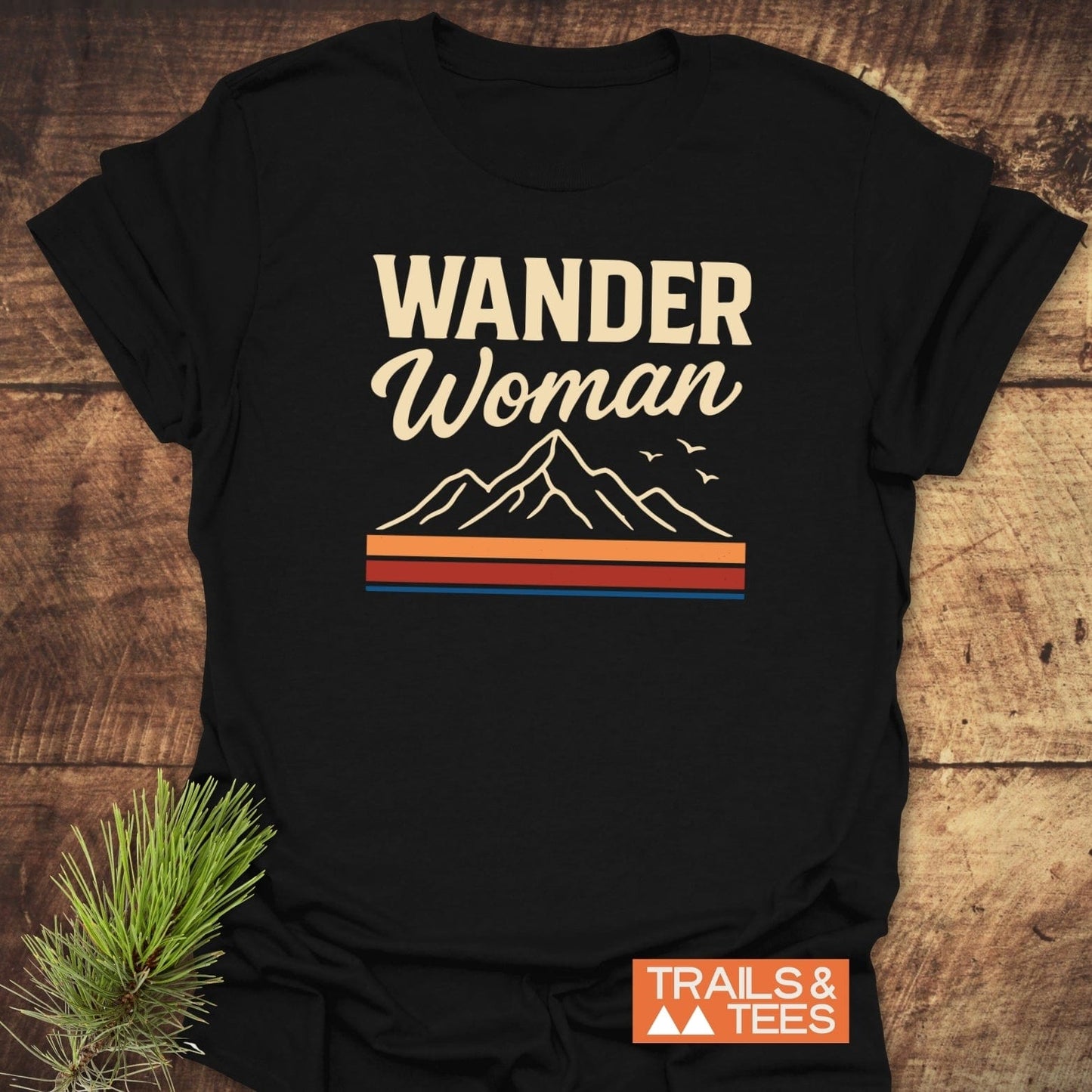 Wander Woman Graphic T-Shirt featuring a vintage mountain design with birds and stripes. Made from soft, lightweight cotton for everyday outdoor adventures.