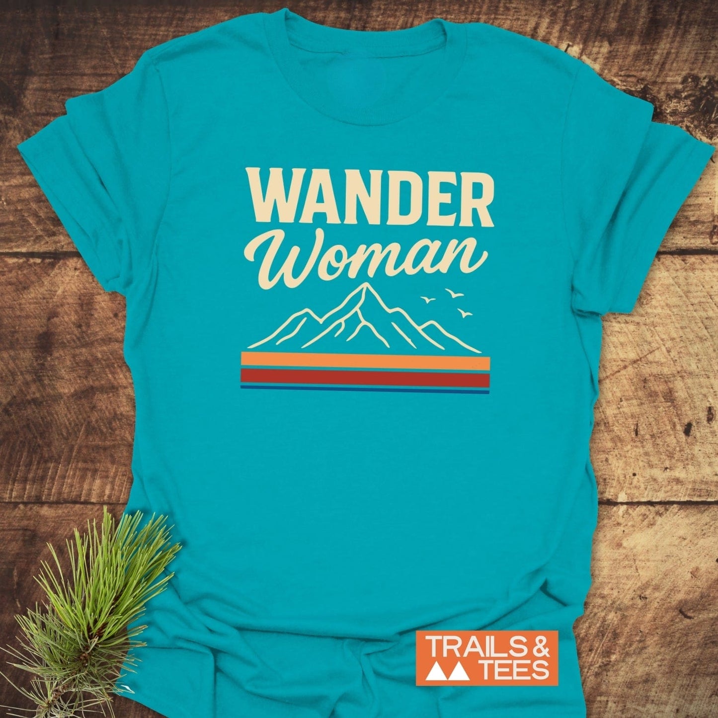 Wander Woman Graphic T-Shirt featuring mountain peaks and birds graphic, crafted from soft cotton, designed for comfort and adventure, with durable, fade-resistant print.