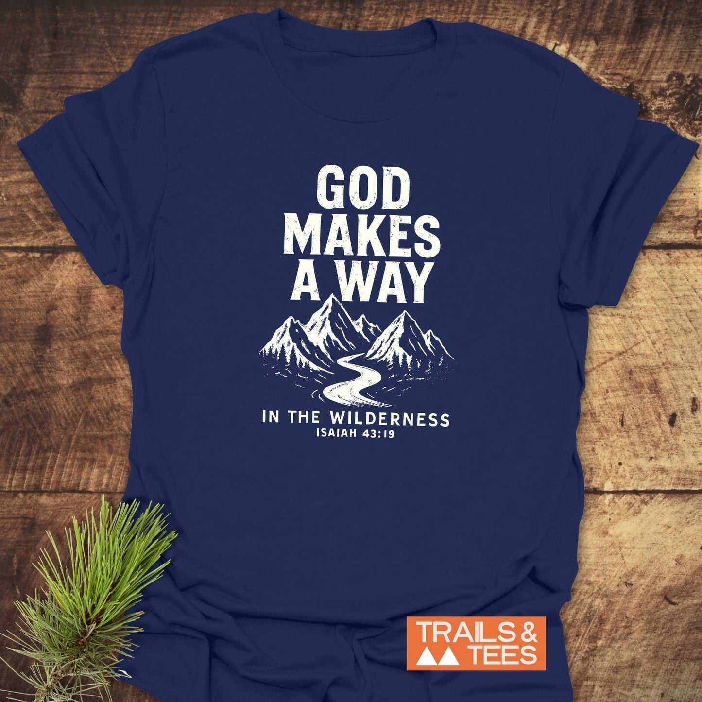 God Makes A Way T-Shirt featuring a white mountain and river graphic with biblical text, on a navy-blue, soft, ring-spun cotton fabric, ideal for outdoor enthusiasts.