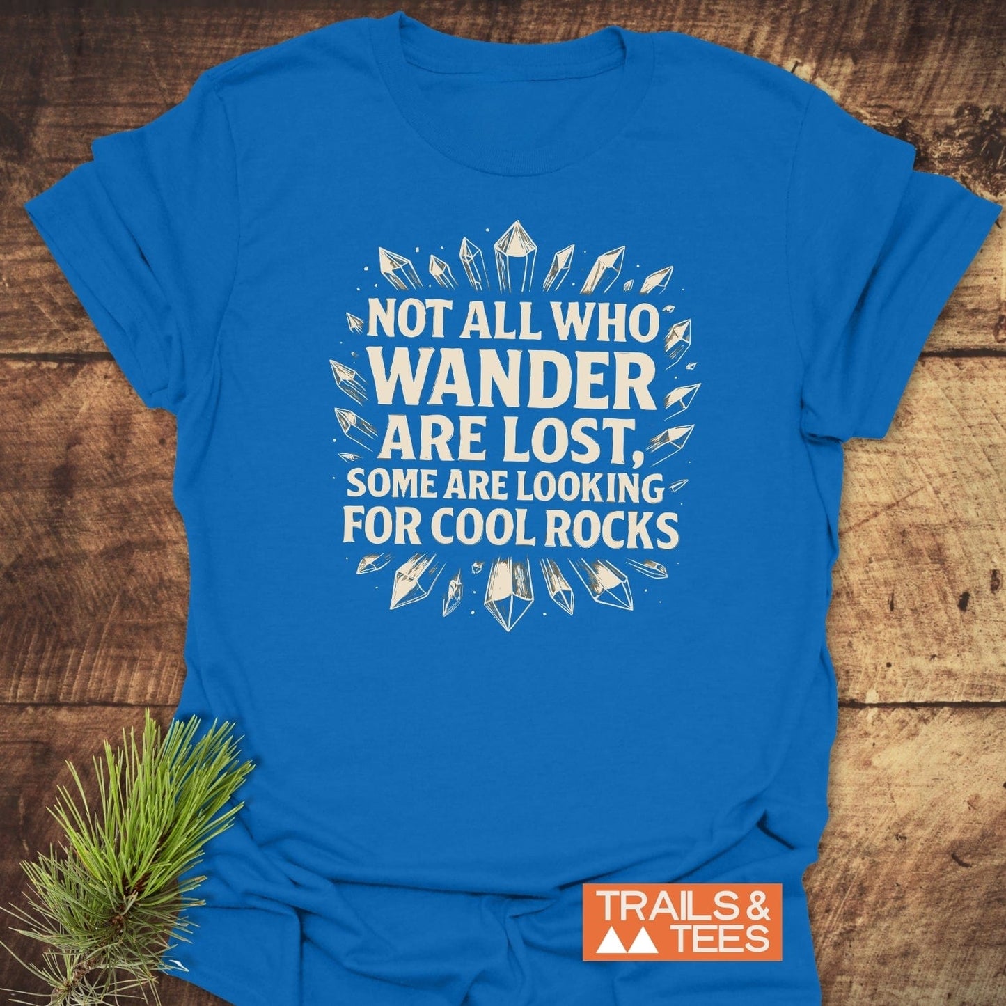 764 Not All... Rock Lover T-Shirt with white slogan and crystal illustrations on a blue tee, featuring durable prints and a small TRAILS & TEES logo.
