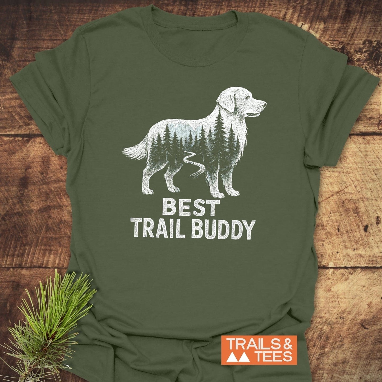 Best Trail Buddy Golden Retriever T-Shirt featuring a dog silhouette filled with trees and trail, BEST TRAIL BUDDY text, and TRAILS & TEES logo.
