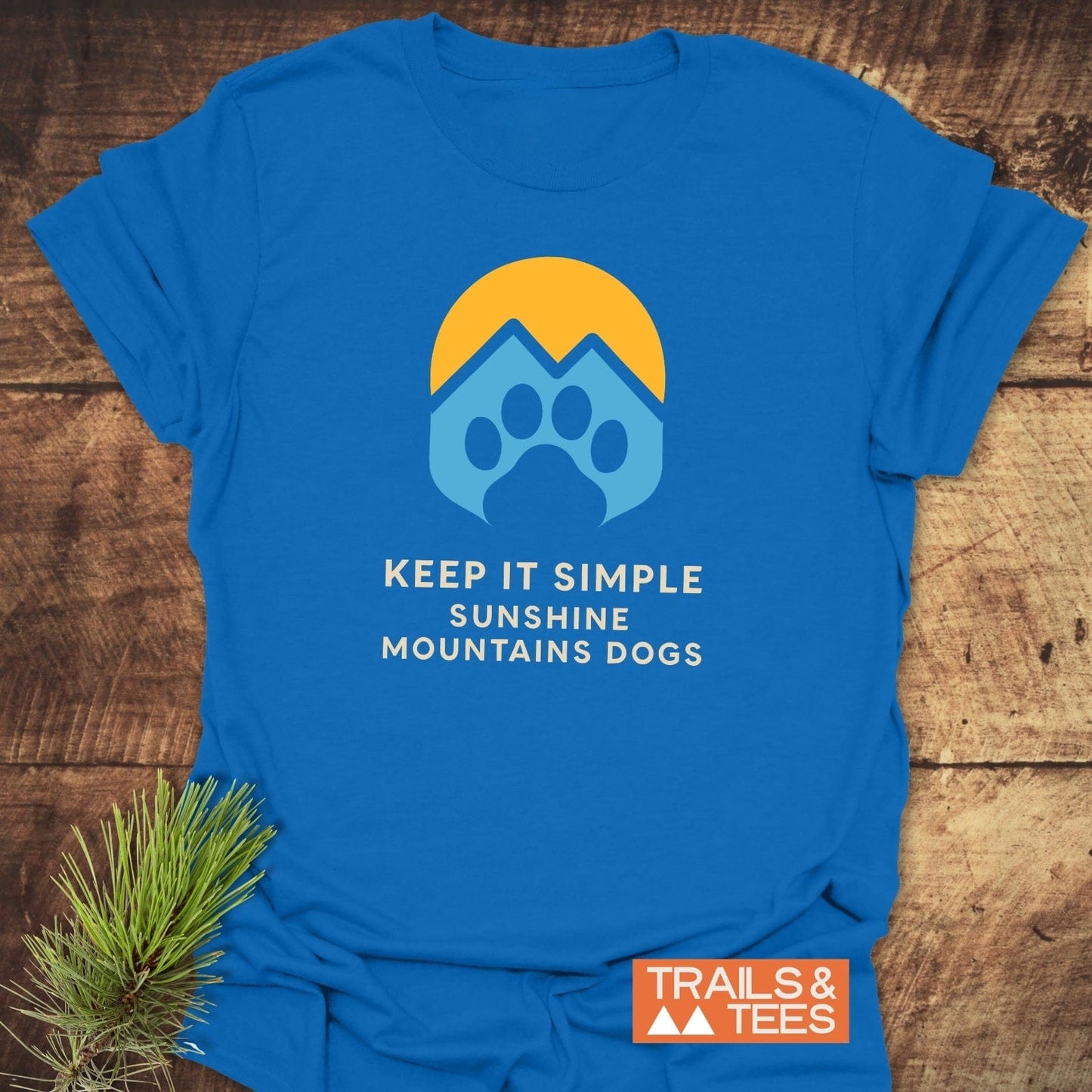 Sun Mountains Dogs T-Shirt featuring a graphic of a sun, mountains, and paw print. Made from soft cotton, ideal for outdoor enthusiasts.