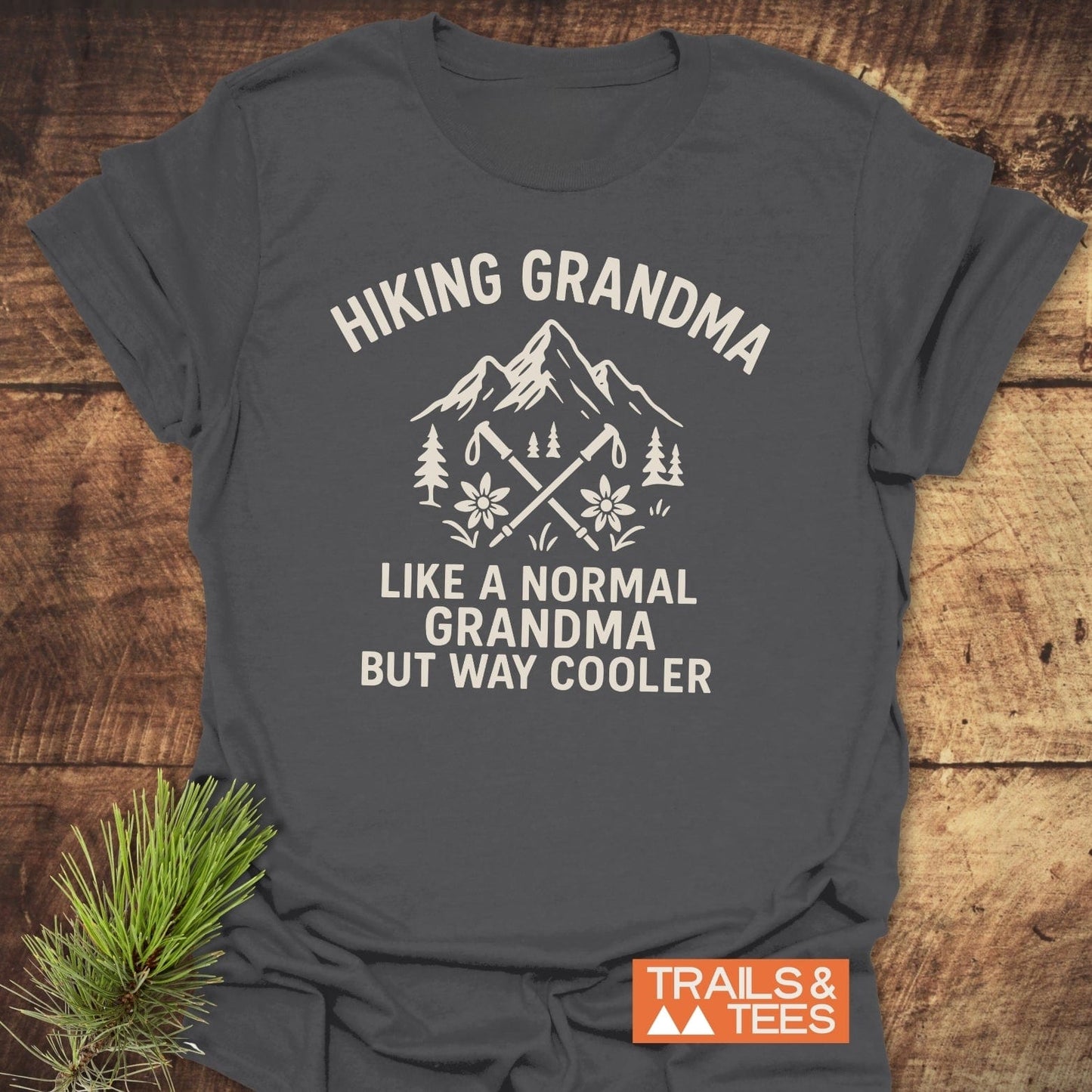 Hiking Grandma Mountain T-Shirt with mountain and hiking pole design, made of soft cotton for comfort, pre-shrunk for fit, featuring durable prints.