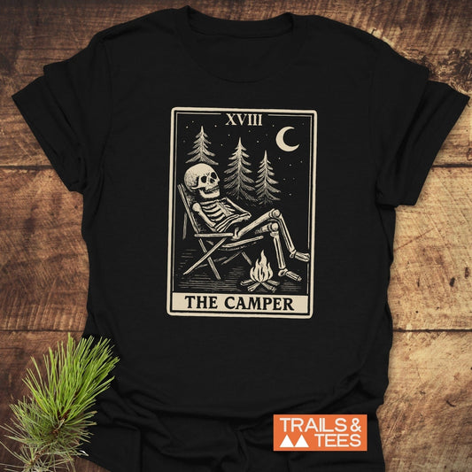The Camper Tarot T-Shirt: vintage tarot illustration of a skeleton camping, crafted from soft cotton for lasting comfort and outdoor style.