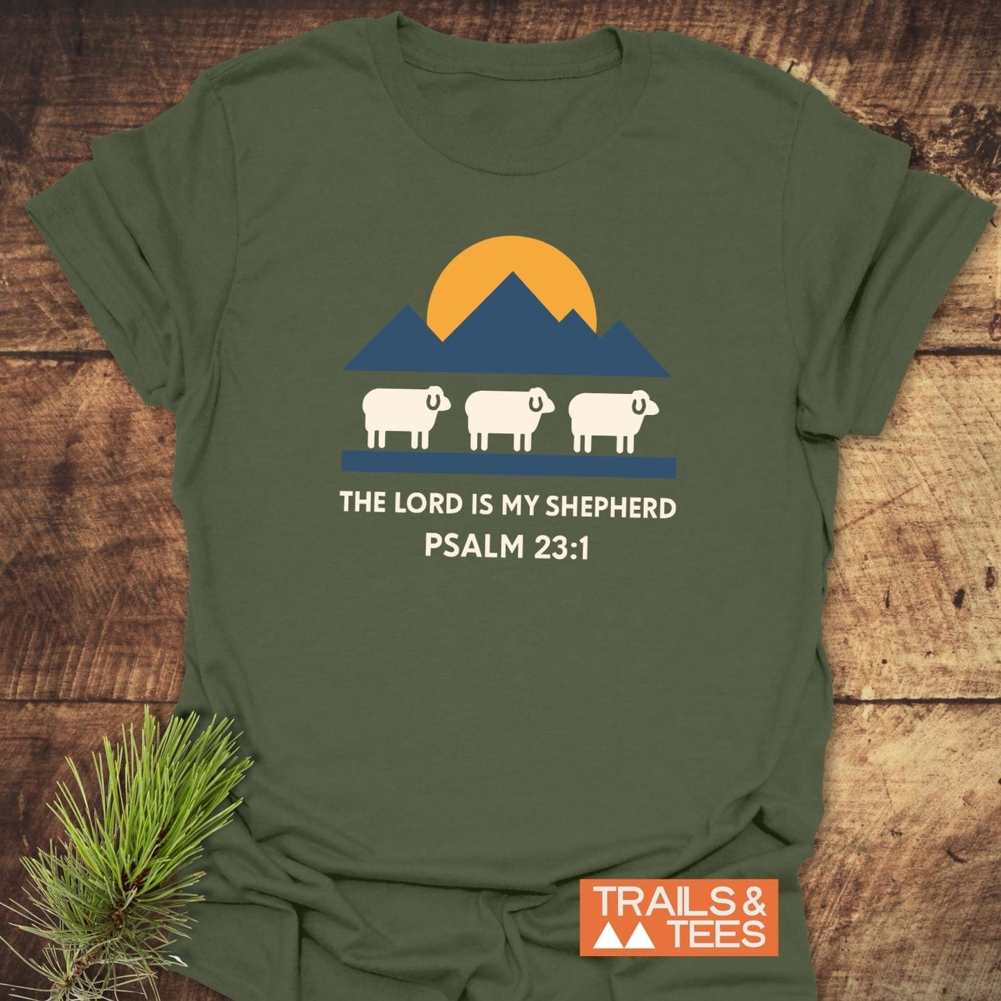 The Lord Is My Shepherd T-Shirt features a mountain graphic with sheep and text, highlighting outdoor-inspired design and comfort-focused, durable cotton construction.