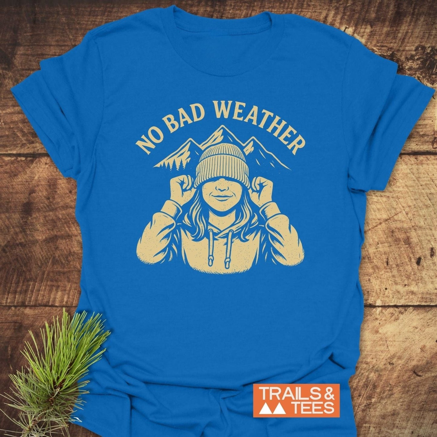 No Bad Weather T-Shirt with a rustic graphic of a hooded figure and mountains, emphasizing comfort and adventure.