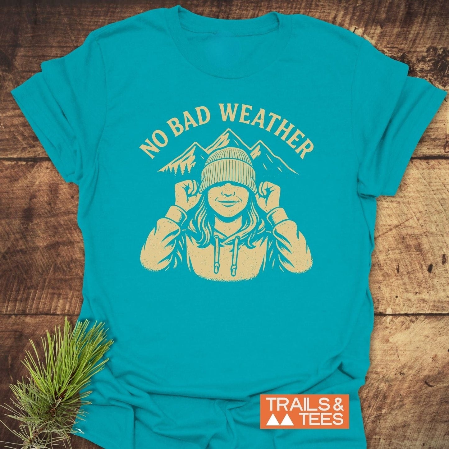 No Bad Weather T-Shirt featuring a sketch of a hooded figure with mountains, crafted from soft cotton, perfect for outdoor enthusiasts.