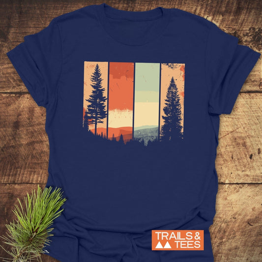 Striped Mountains Retro T-Shirt with vintage-style mountain and pine tree graphic on navy-blue, displayed on rustic wood. Eco-friendly, soft cotton, perfect for outdoor enthusiasts.